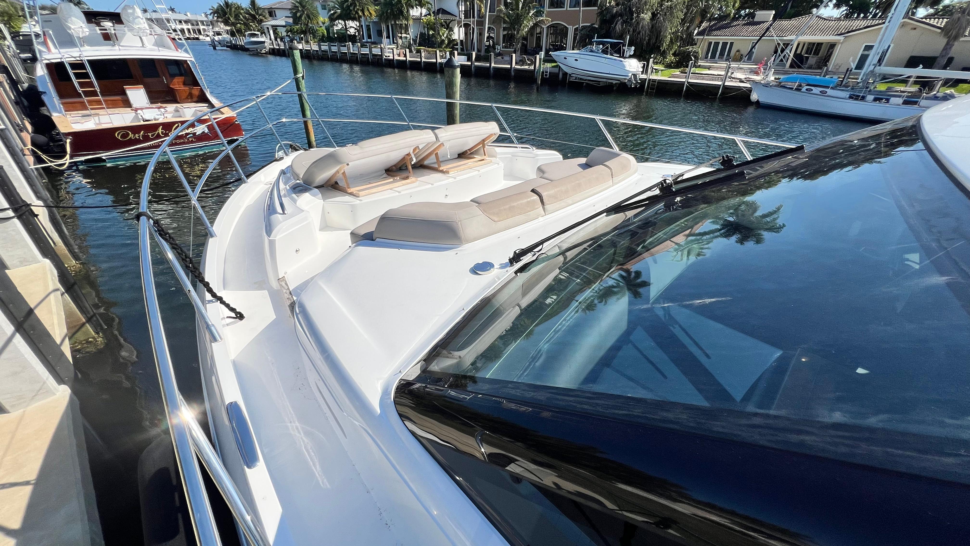 2019 Princess F62 yacht docked in a marina, featuring spacious deck and luxurious seating.