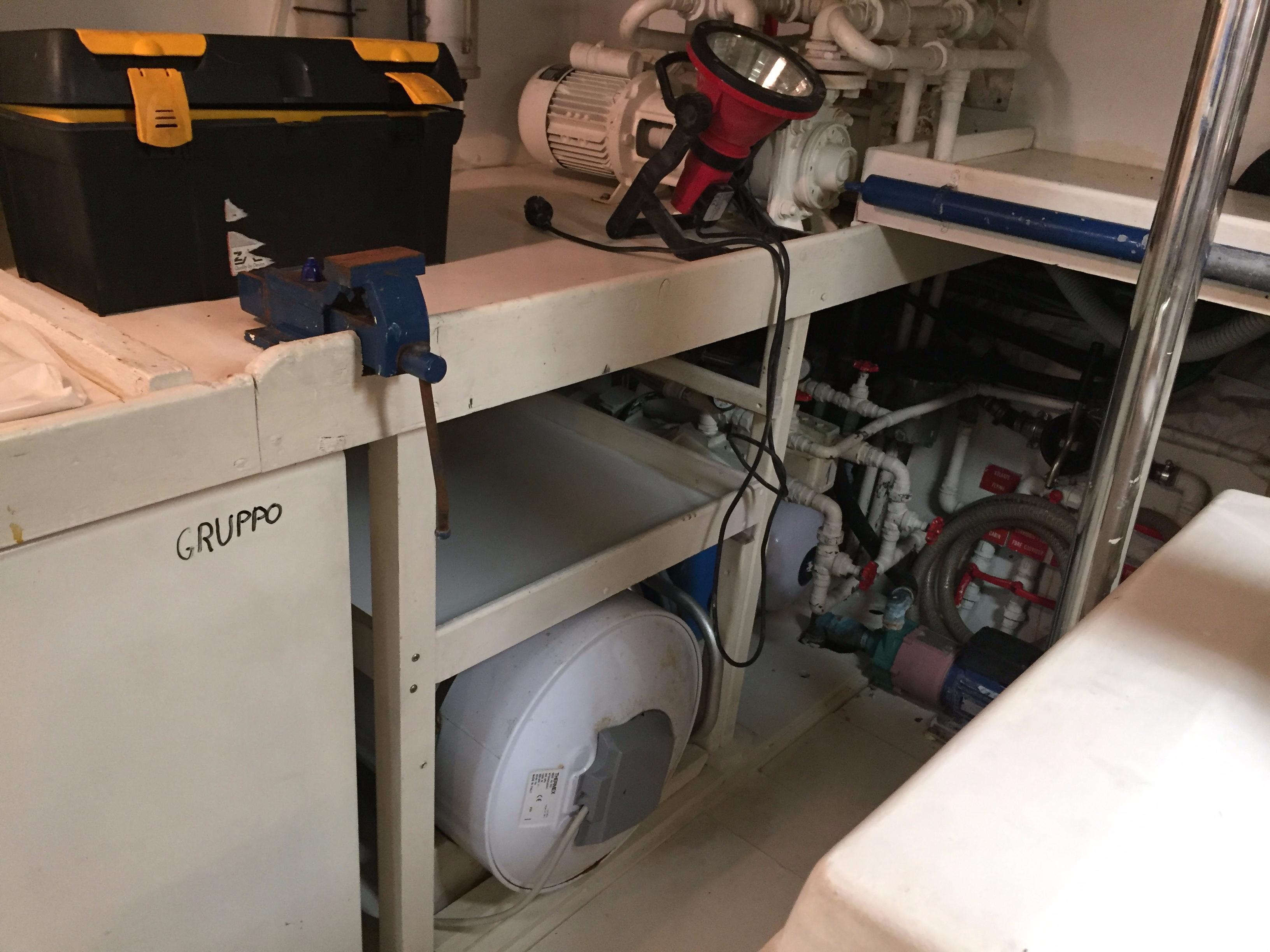 Engine room of a 1994 Falcon 76 yacht with tools and equipment.