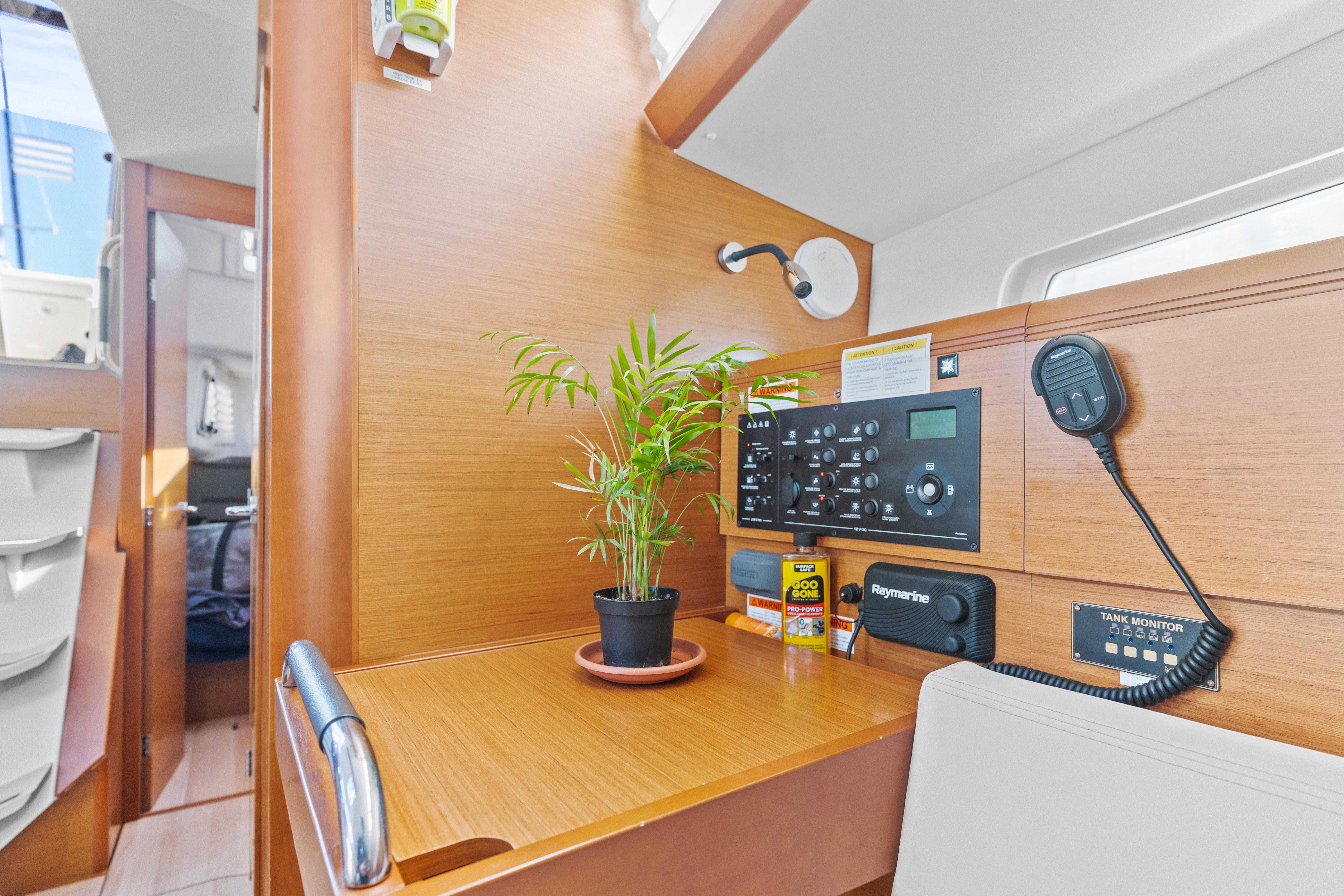 Jeanneau Sun Odyssey 389 interior, 2020 model, featuring navigation panel and potted plant.