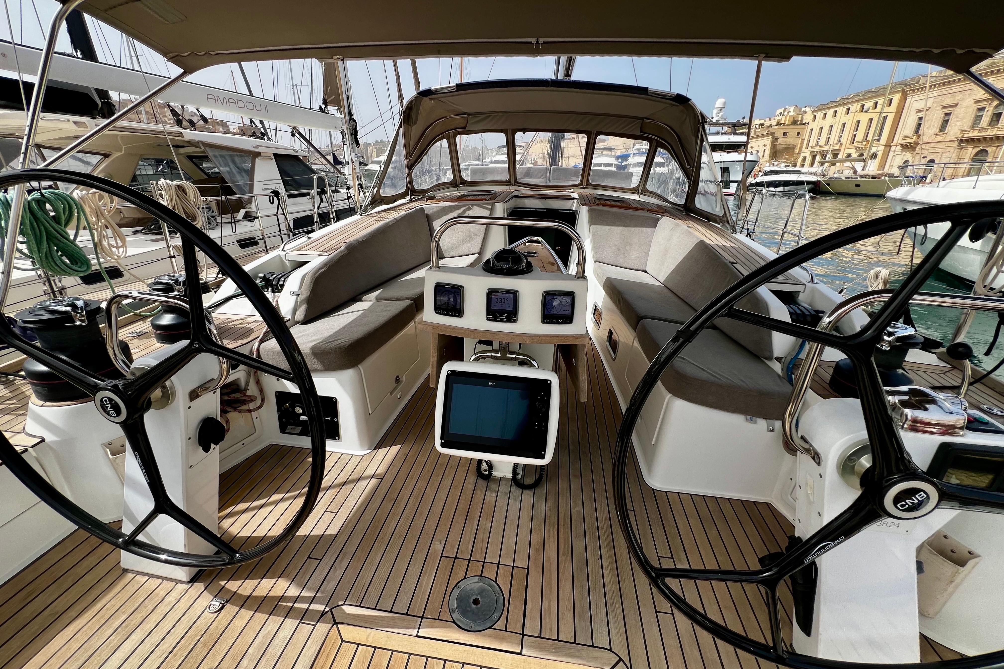 Luxurious 2009 CNB BORDEAUX 60 yacht cockpit with dual steering wheels and navigation instruments.