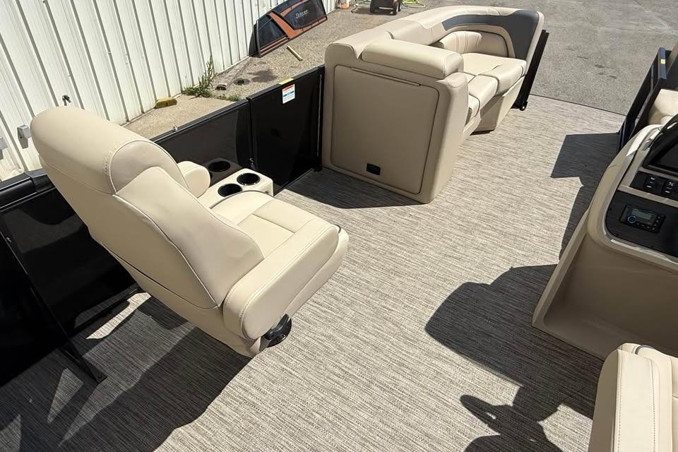 2026 Godfrey Sweetwater 2286 SFLC boat interior with beige seating and carpet flooring.