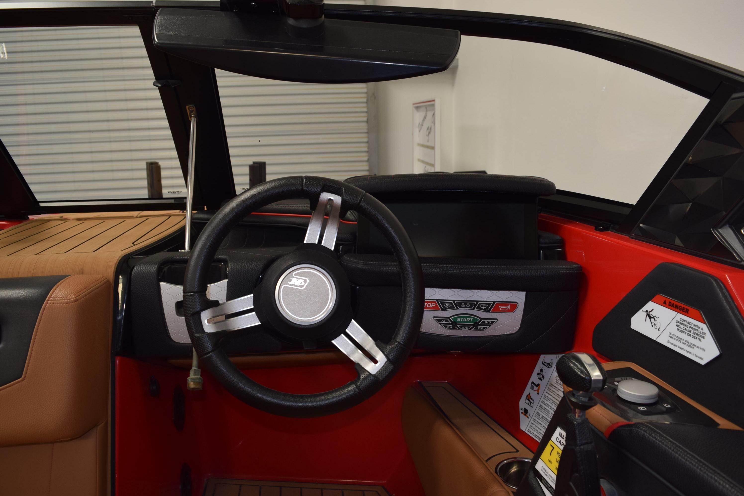 2024 Nautique Ski Nautique boat interior with steering wheel and dashboard controls.