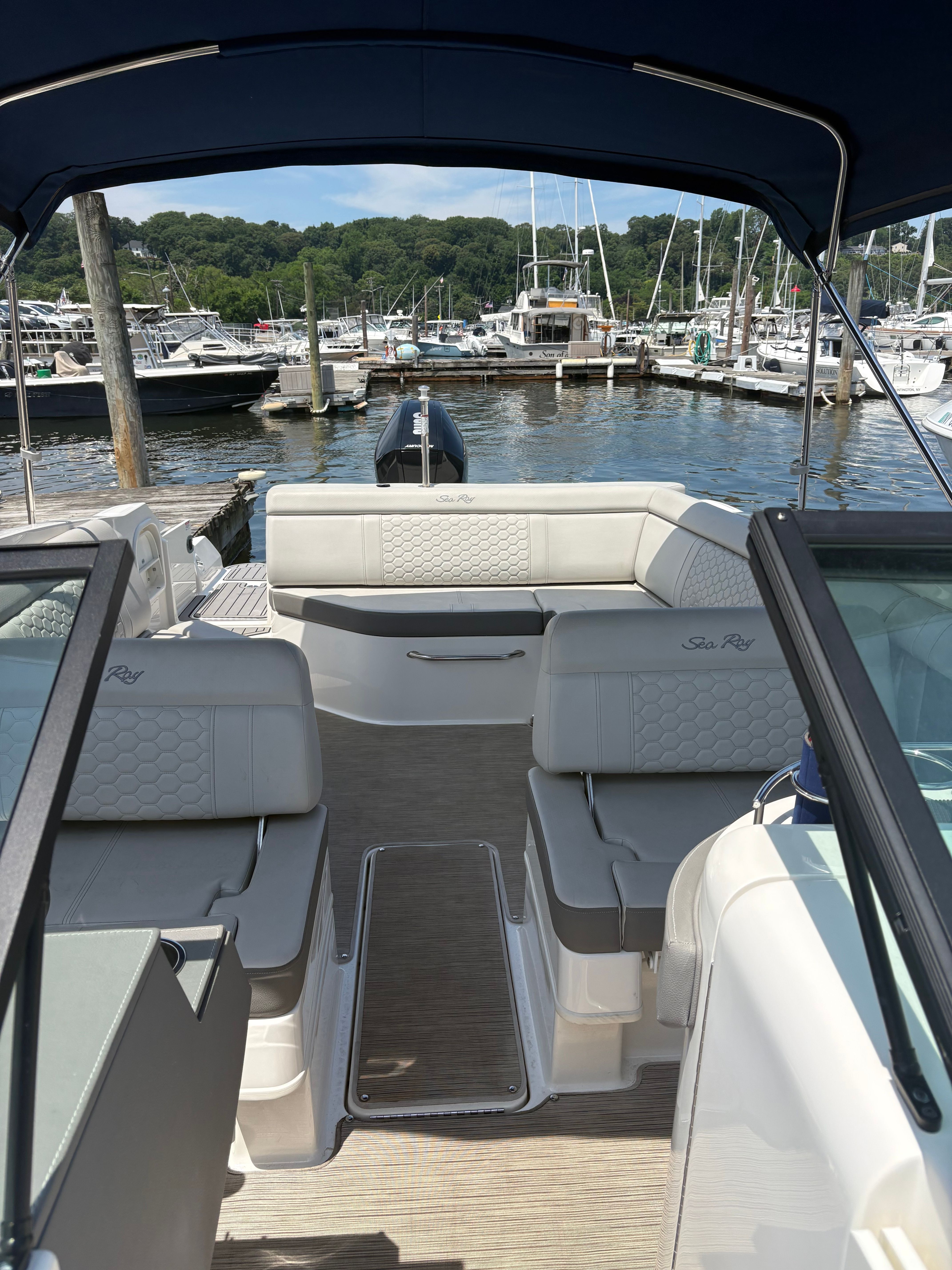 The image shows the interior of a 2022 Sea Ray SDX 270 Outboard boat docked at a marina.