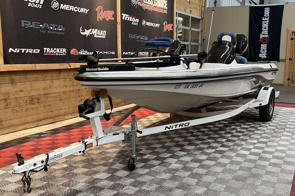 2005 Nitro NX 750 boat on trailer in showroom, featuring MotorGuide equipment.