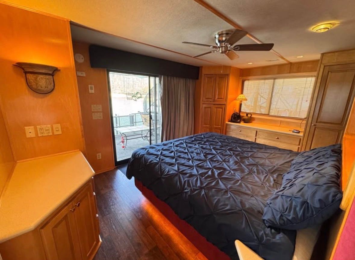 Interior of a 1998 Stardust Cruisers houseboat with bedroom.