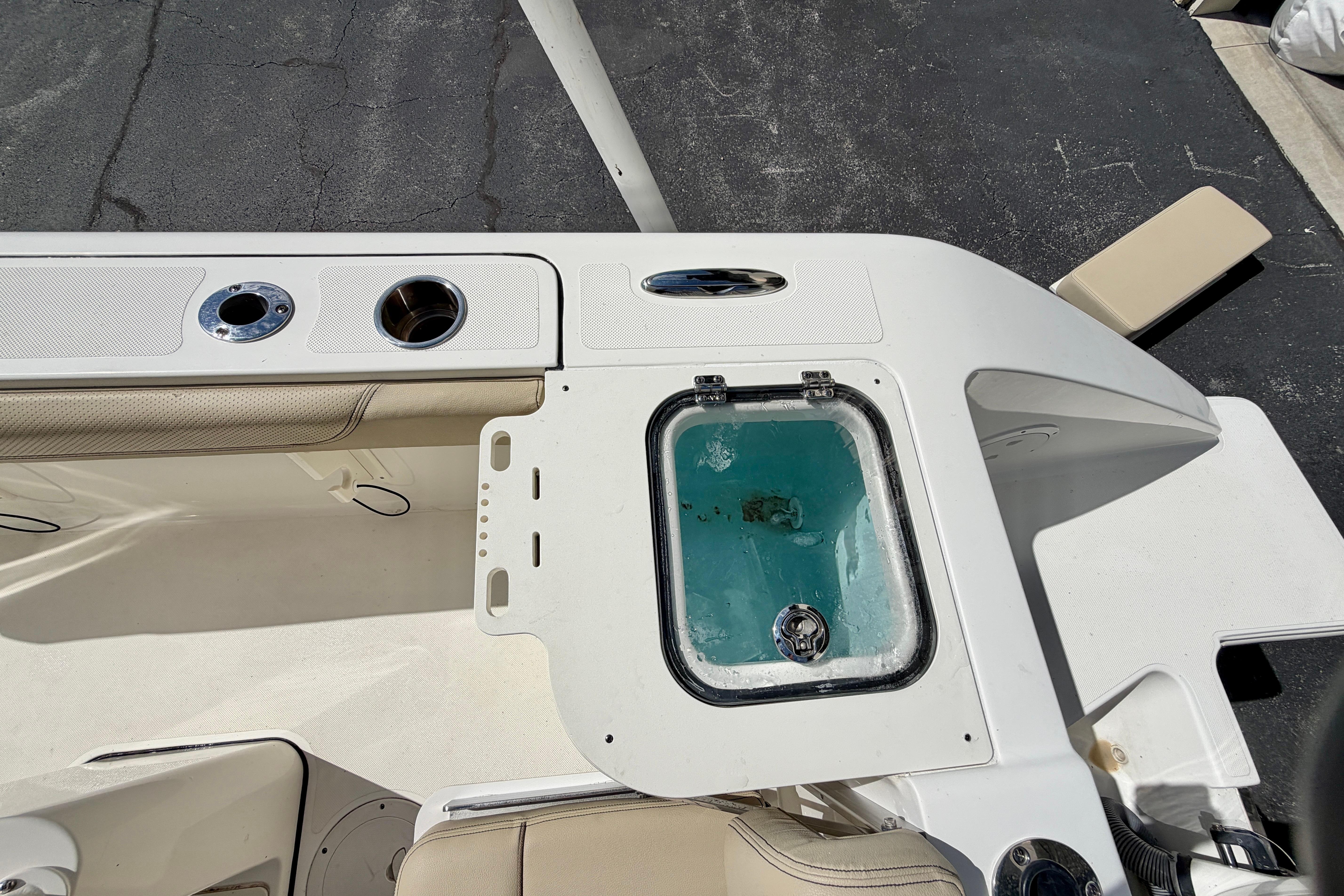 2020 Pursuit C 238 Center Console boat interior with livewell and cup holders.