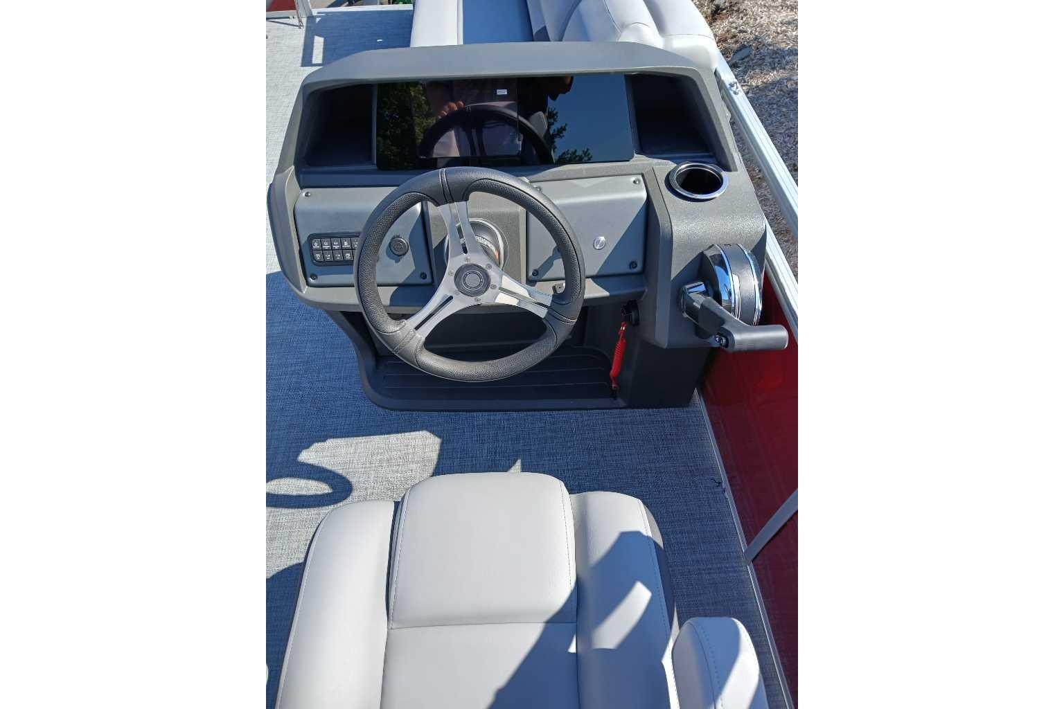 2026 Sun Tracker SportFish 20 DLX boat console with steering wheel and controls.