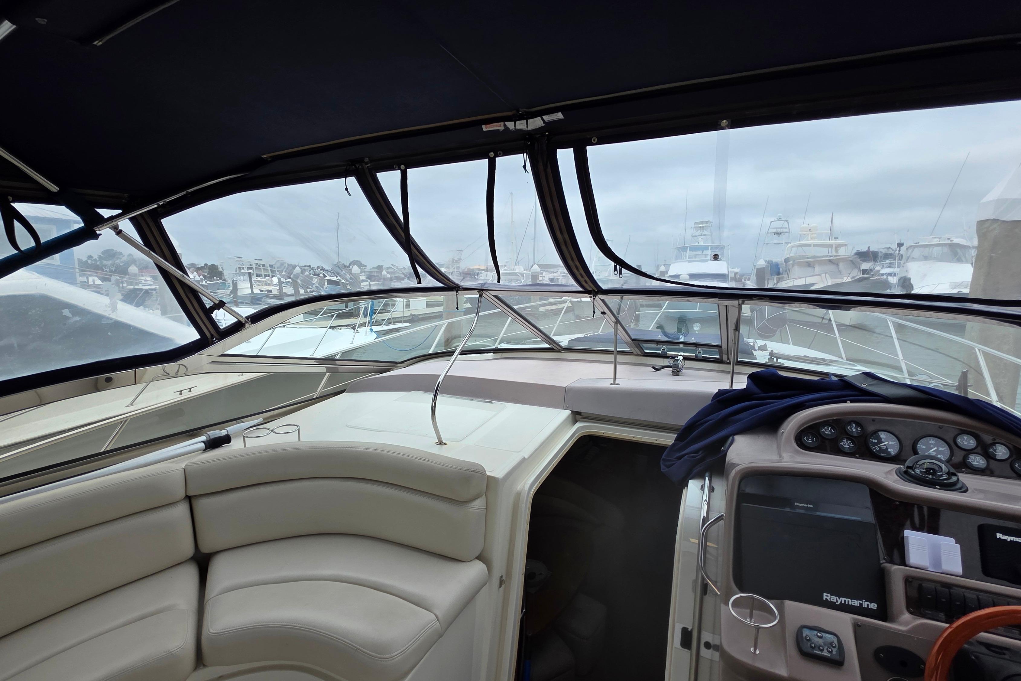 Interior view of a 2002 Regal Commodore 4260 yacht, featuring helm and seating area.
