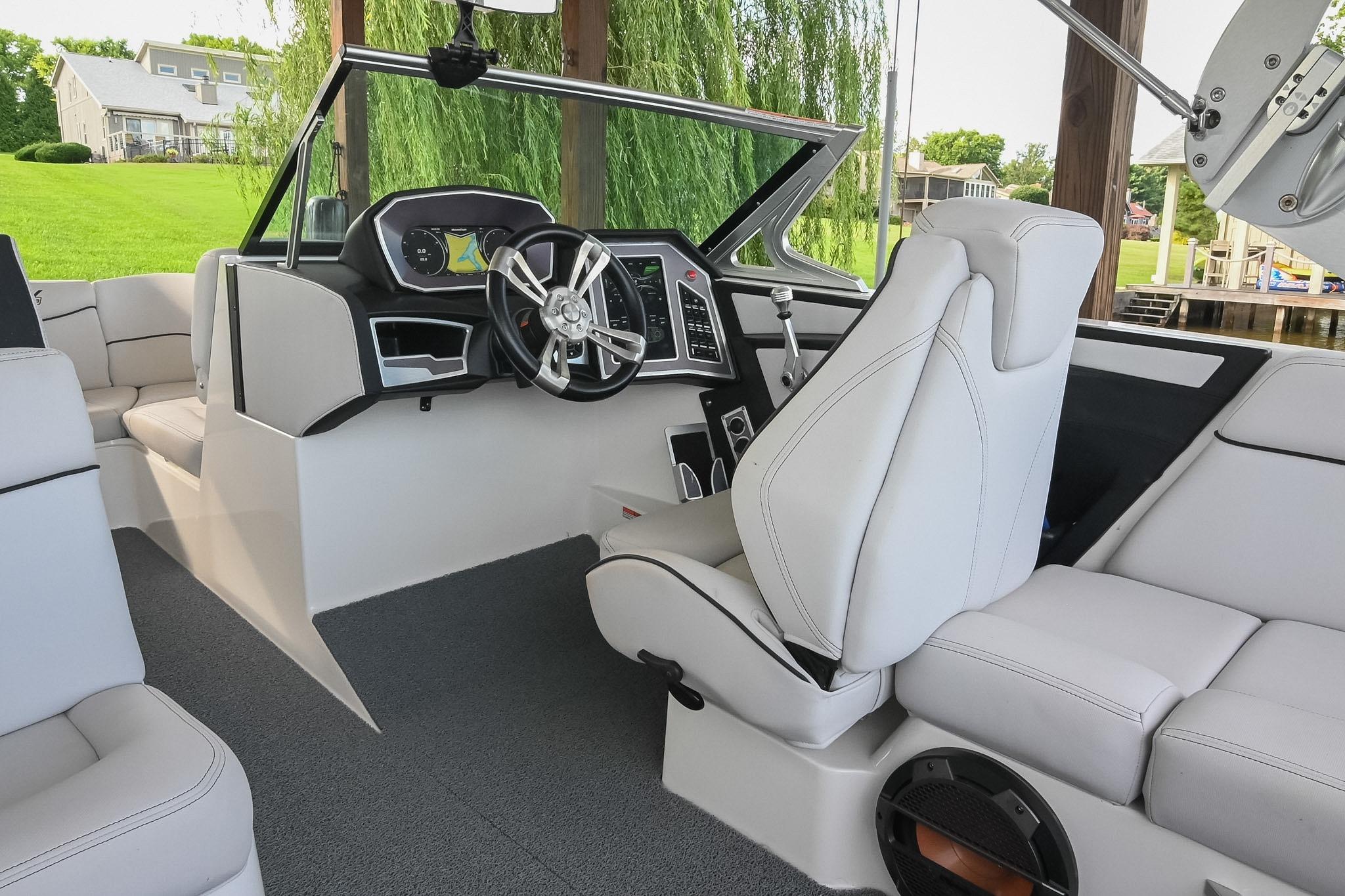 2018 MasterCraft X23 boat interior with modern dashboard and luxurious seating.
