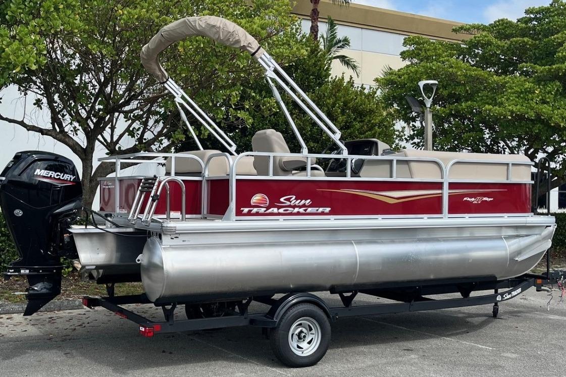 2025 Sun Tracker Party Barge 18 DLX pontoon boat with Mercury engine on trailer.