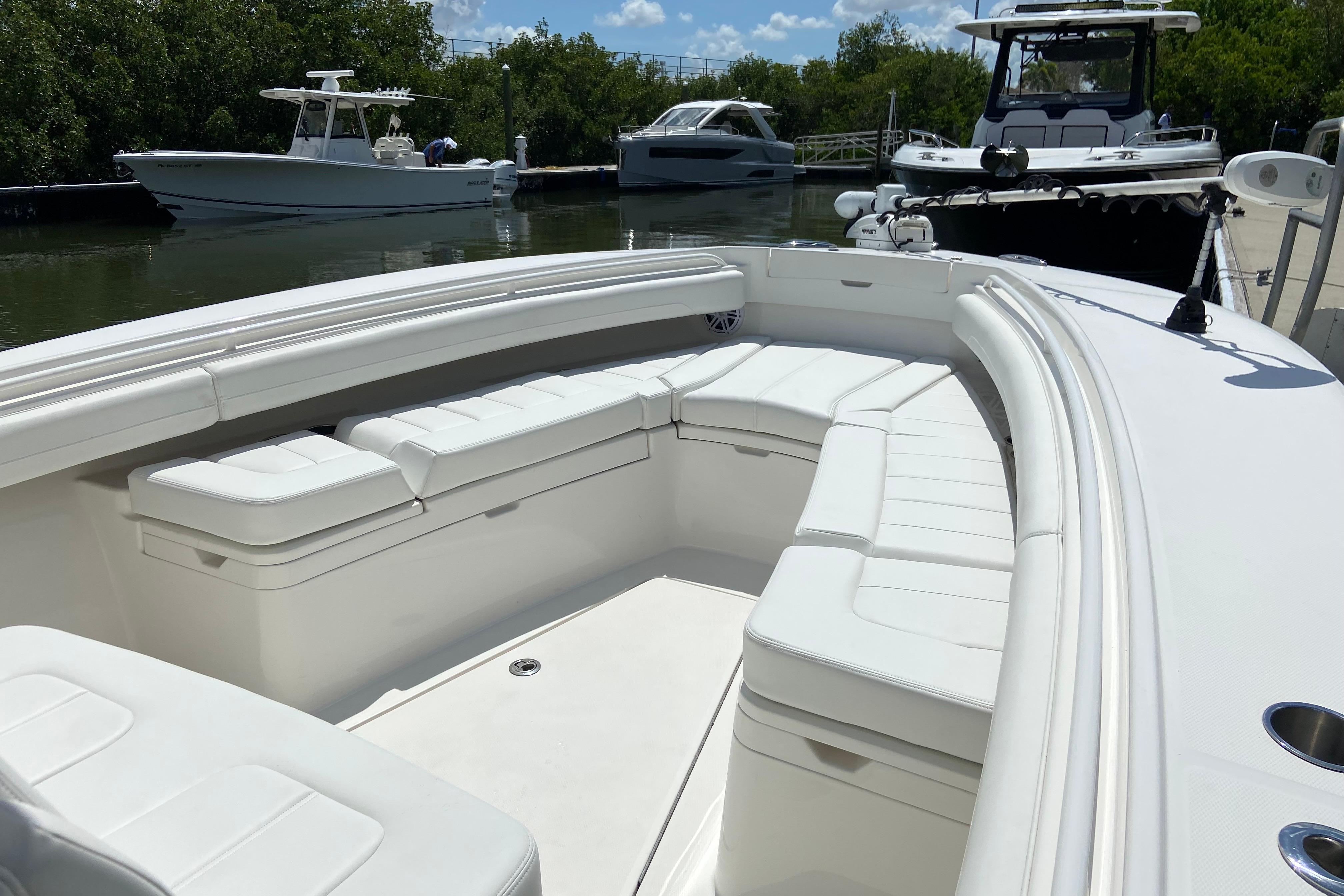 2021 Regulator 28 boat with spacious white seating in a marina setting.