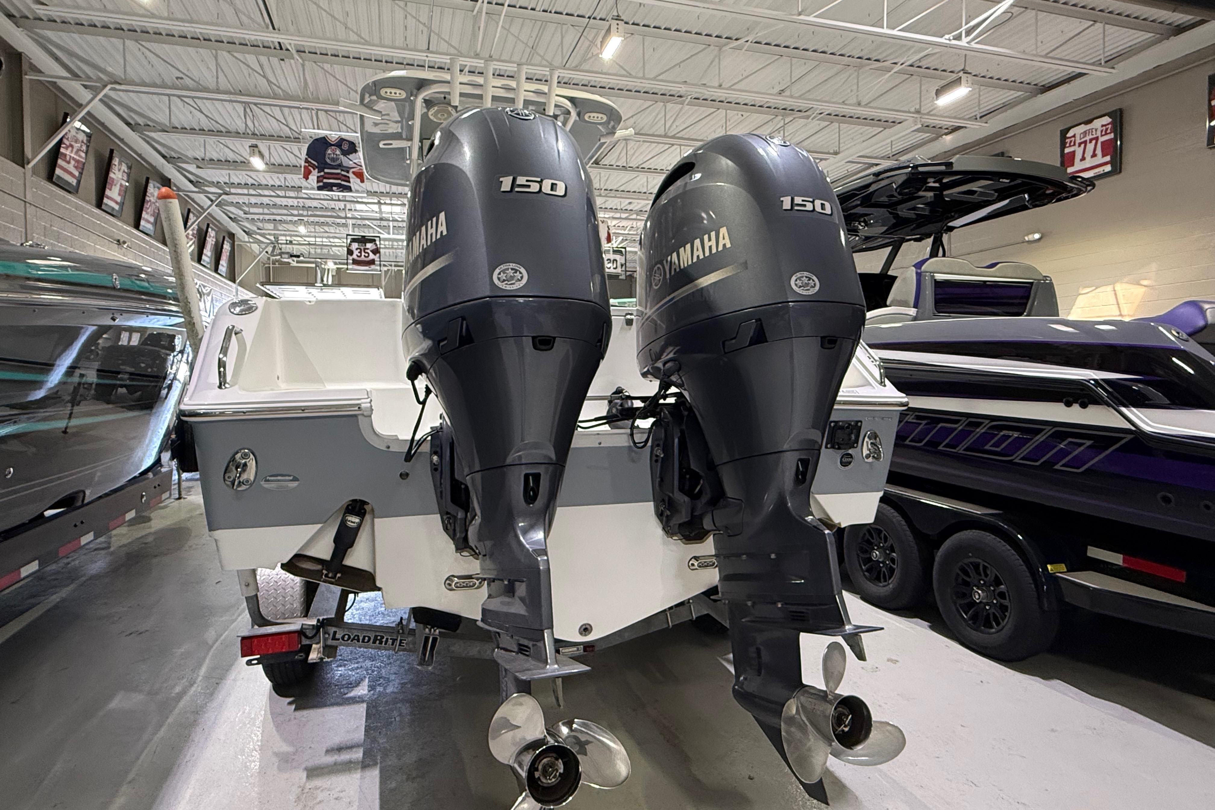 2016 Sea Hunt Gamefish 25 with twin Yamaha 150 engines in showroom.
