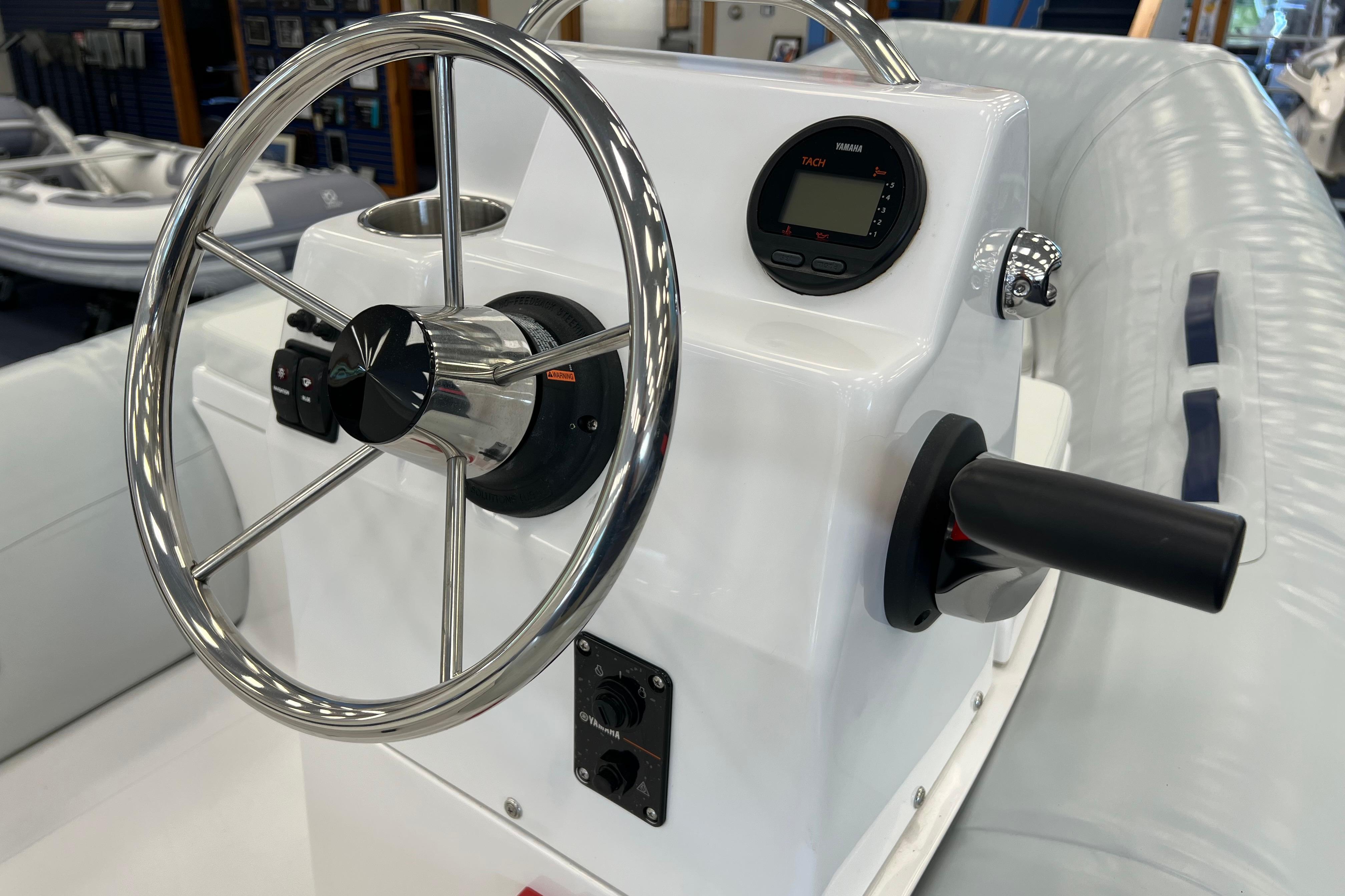 Steering console of 2023 AB Inflatables Mares 12 VSX boat with controls and display.