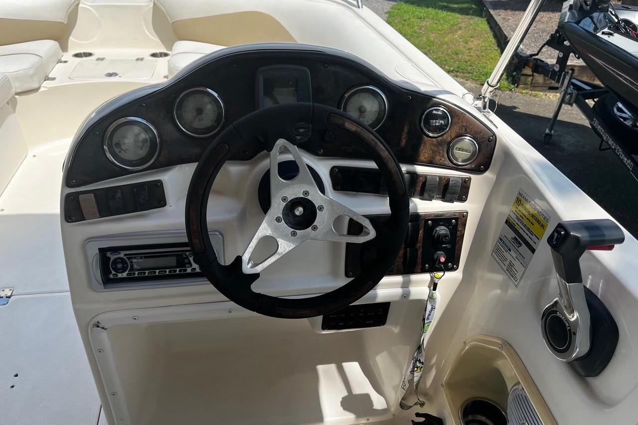 Dashboard of a 2008 Hurricane FD202 boat with steering wheel and controls.