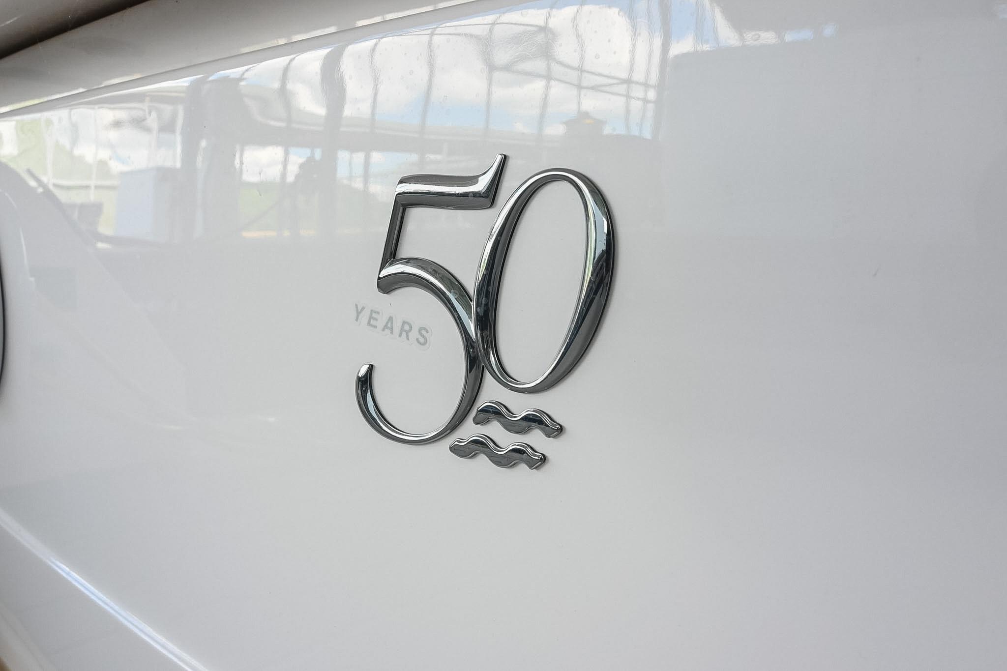 Regal 33 Express 2021 boat, 50th anniversary emblem on white hull.