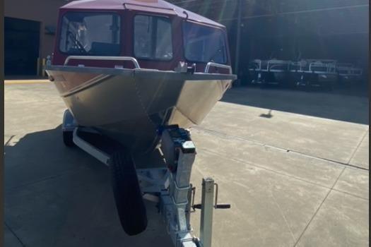 2023 Spartan 200 Astoria boat on trailer in sunny outdoor setting.