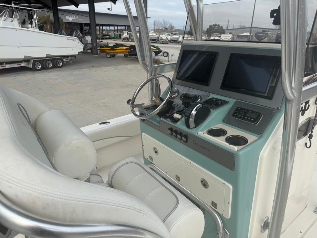 2017 ShearWater 270 Carolina Flare boat console with dual screens and steering wheel.