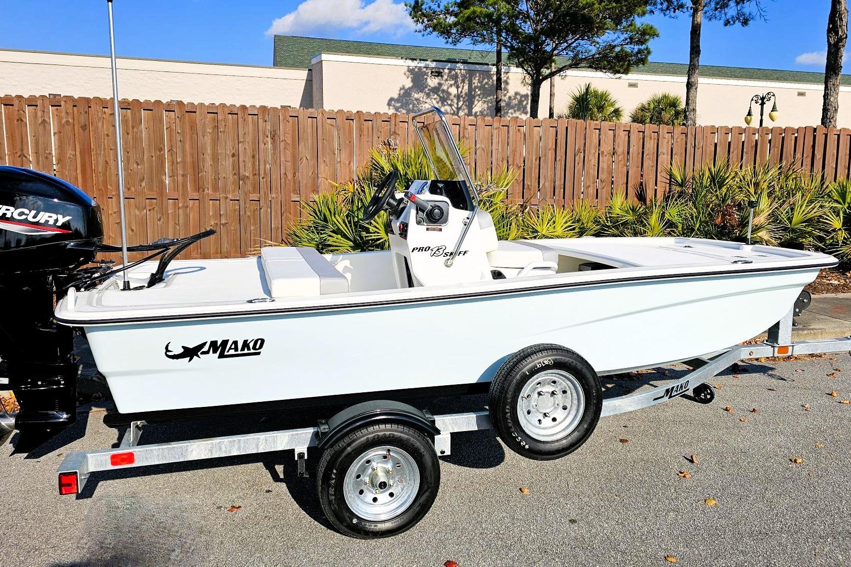 2026 Mako Pro Skiff 13 CC boat on trailer, parked outdoors.