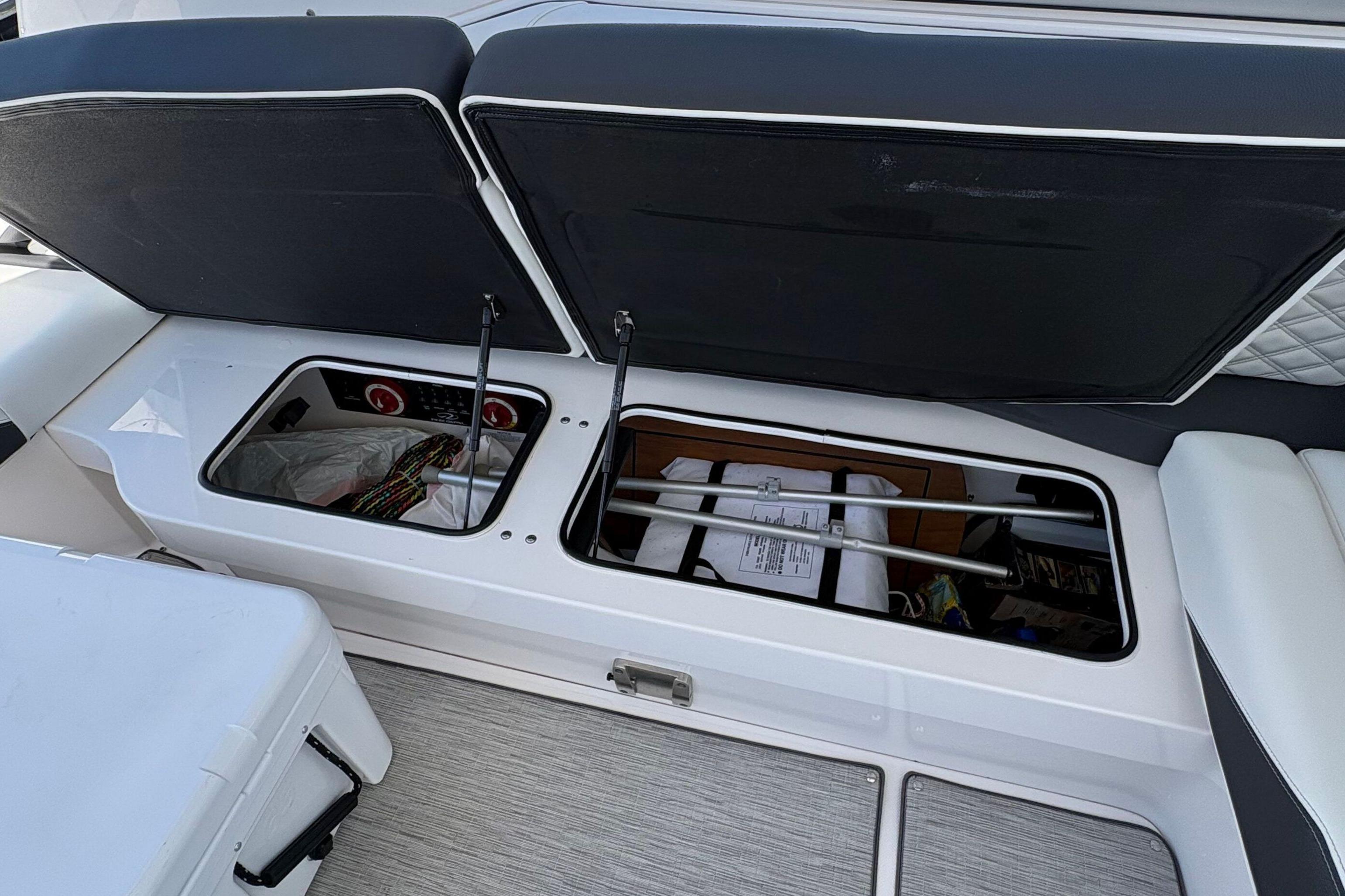 Open storage compartments on a 2020 Regal 33 OBX boat, showcasing interior space.