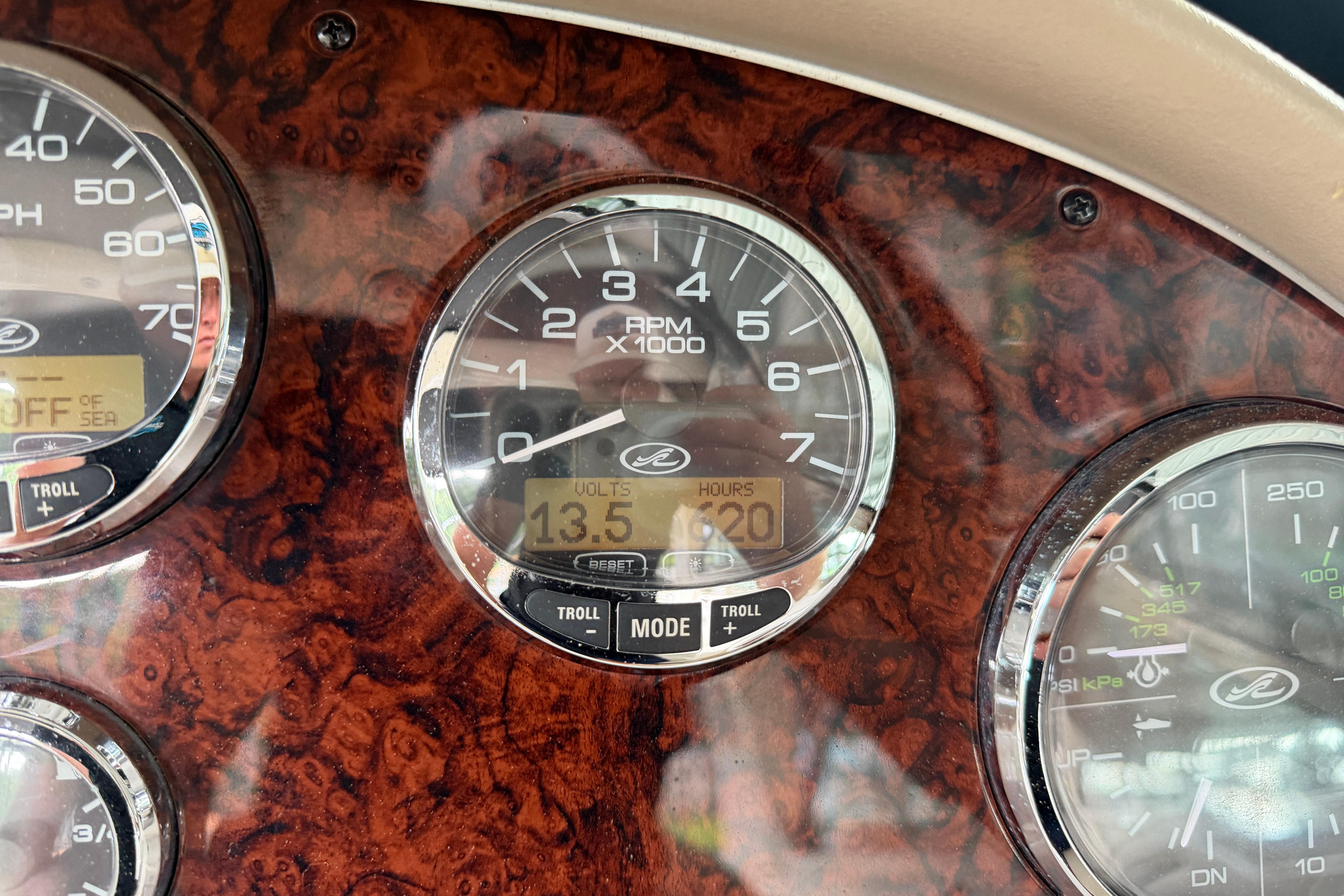 Dashboard of a 2003 Sea Ray 290 Bowrider showing RPM and voltage gauges.