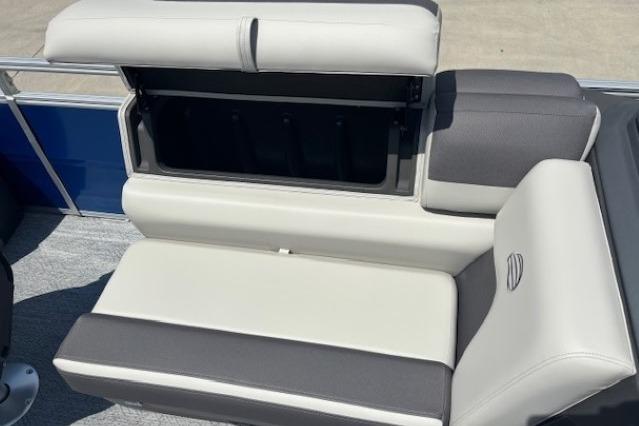 2026 Sun Tracker Fishin' Barge 20 DLX boat seat with storage compartment open.