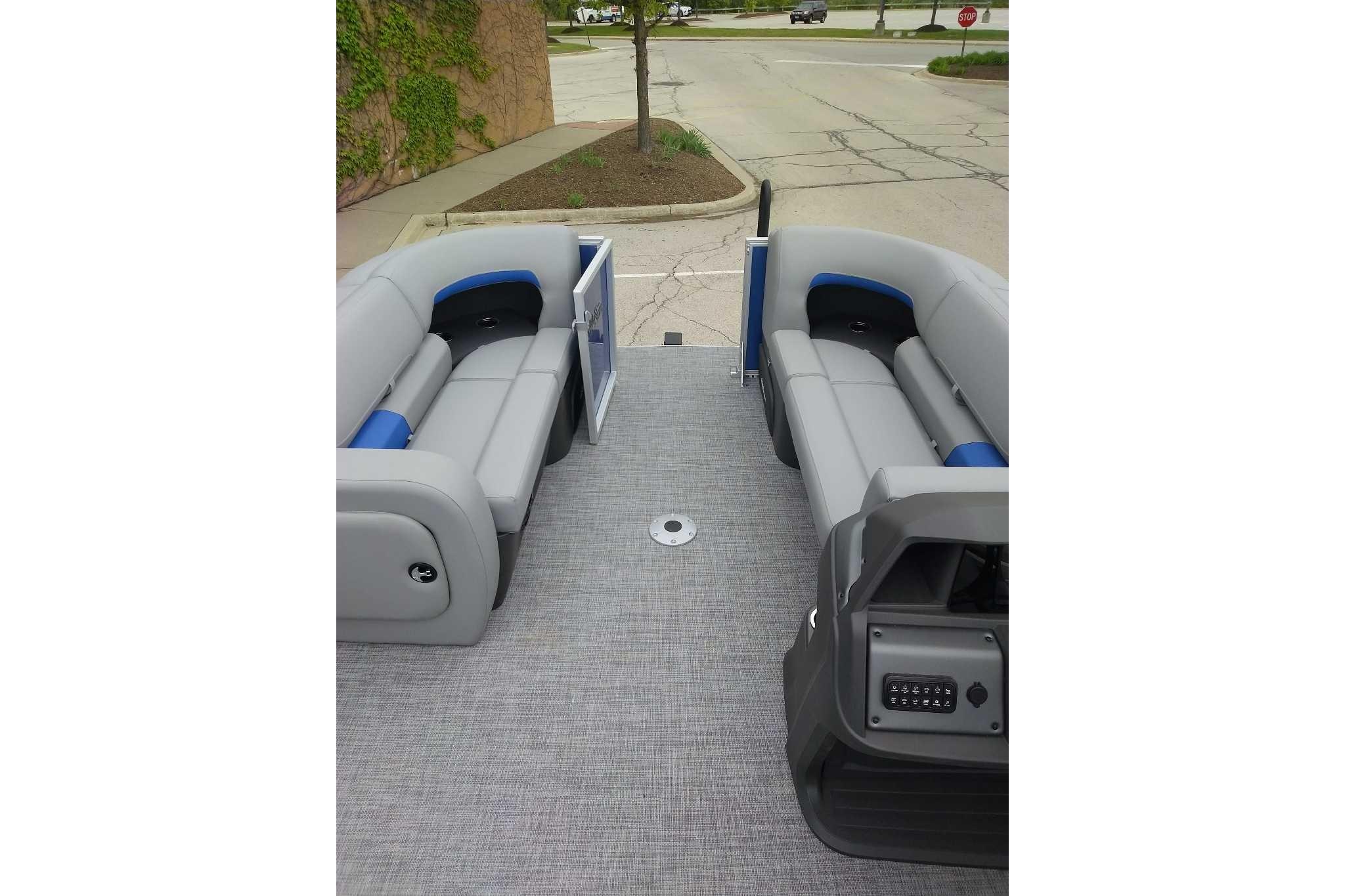 2026 Sun Tracker Party Barge 22 RF DLX interior with gray seating and open deck.