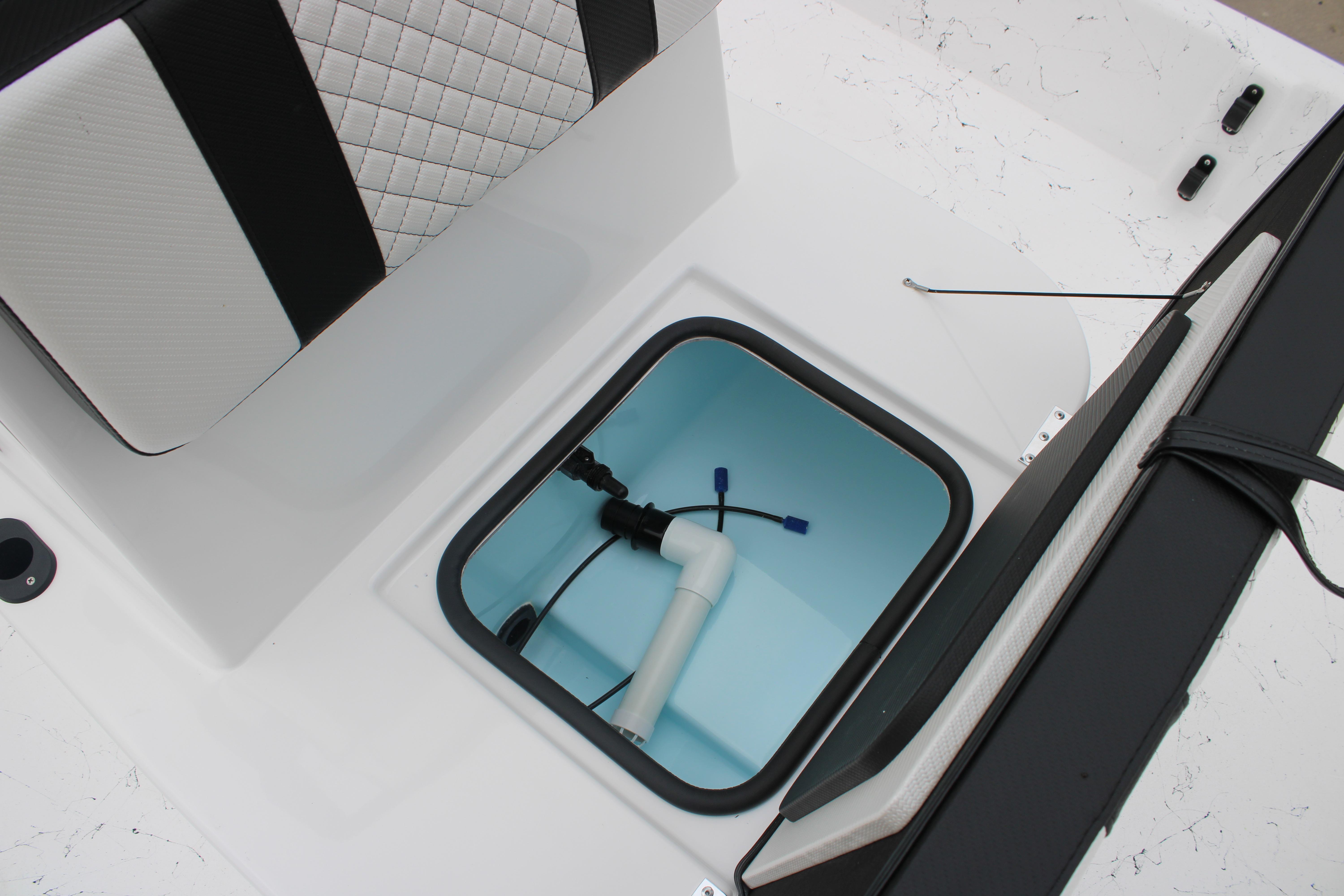 2026 Freedom Boats 16' Eagle interior storage compartment with plumbing components.