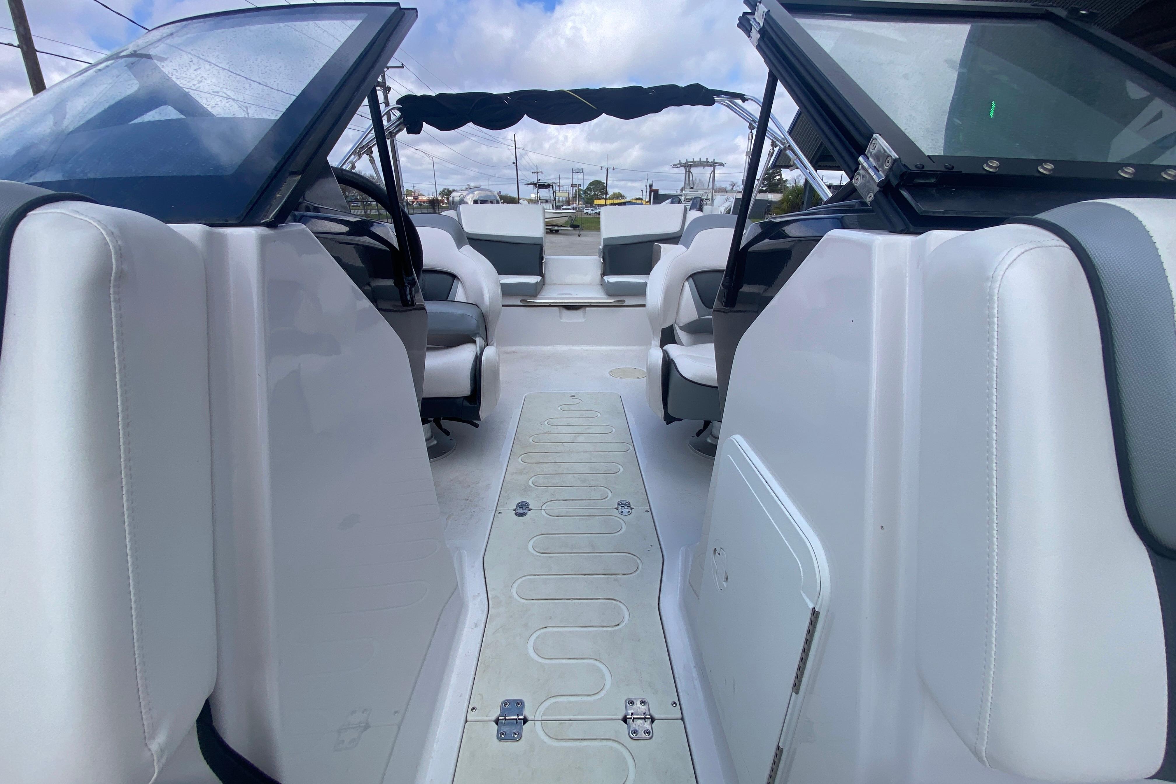 2018 Scarab 215 G boat interior with white seating and open deck layout.