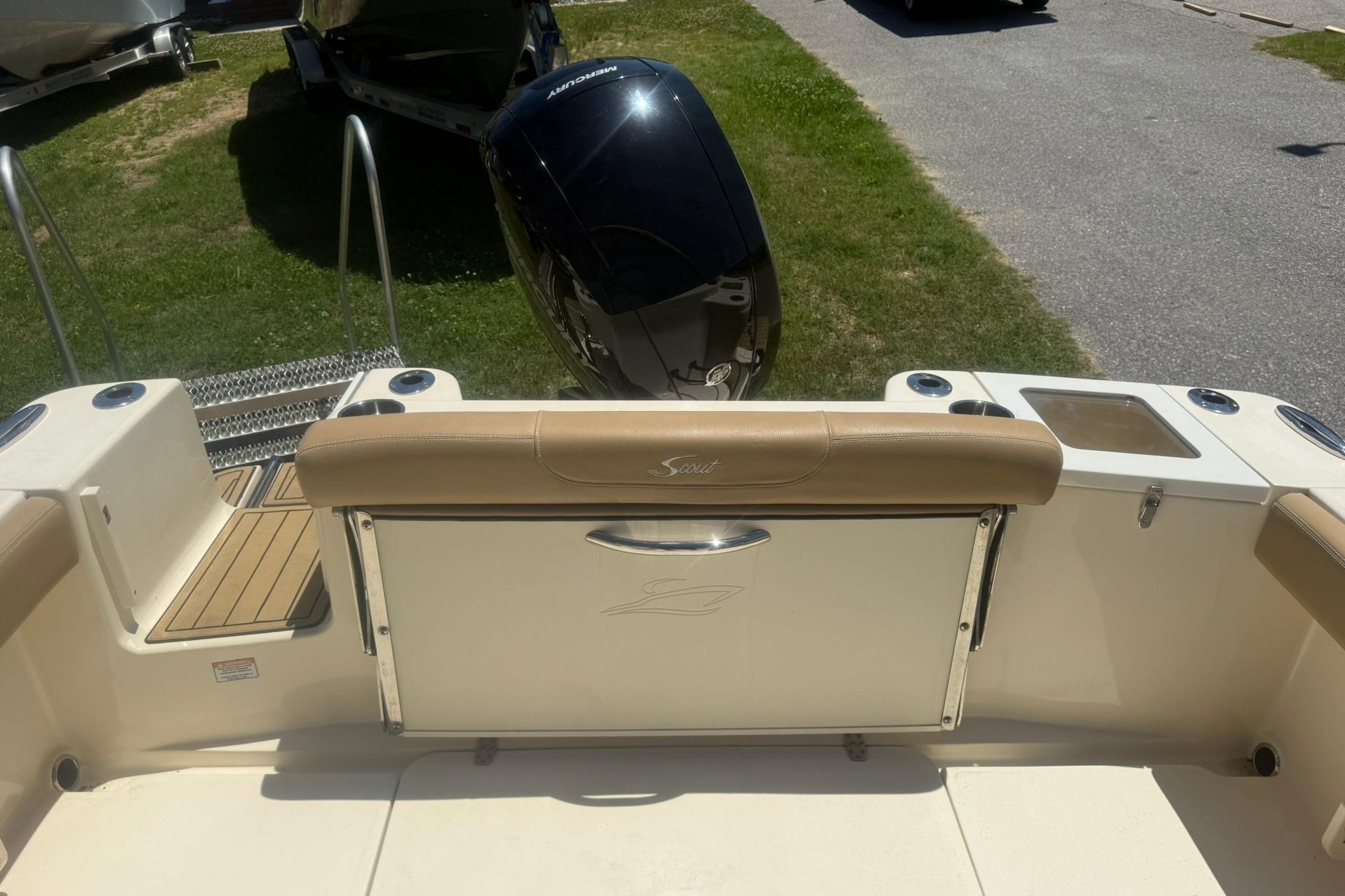 2021 Scout 215 Dorado boat interior with seating and Mercury outboard motor.