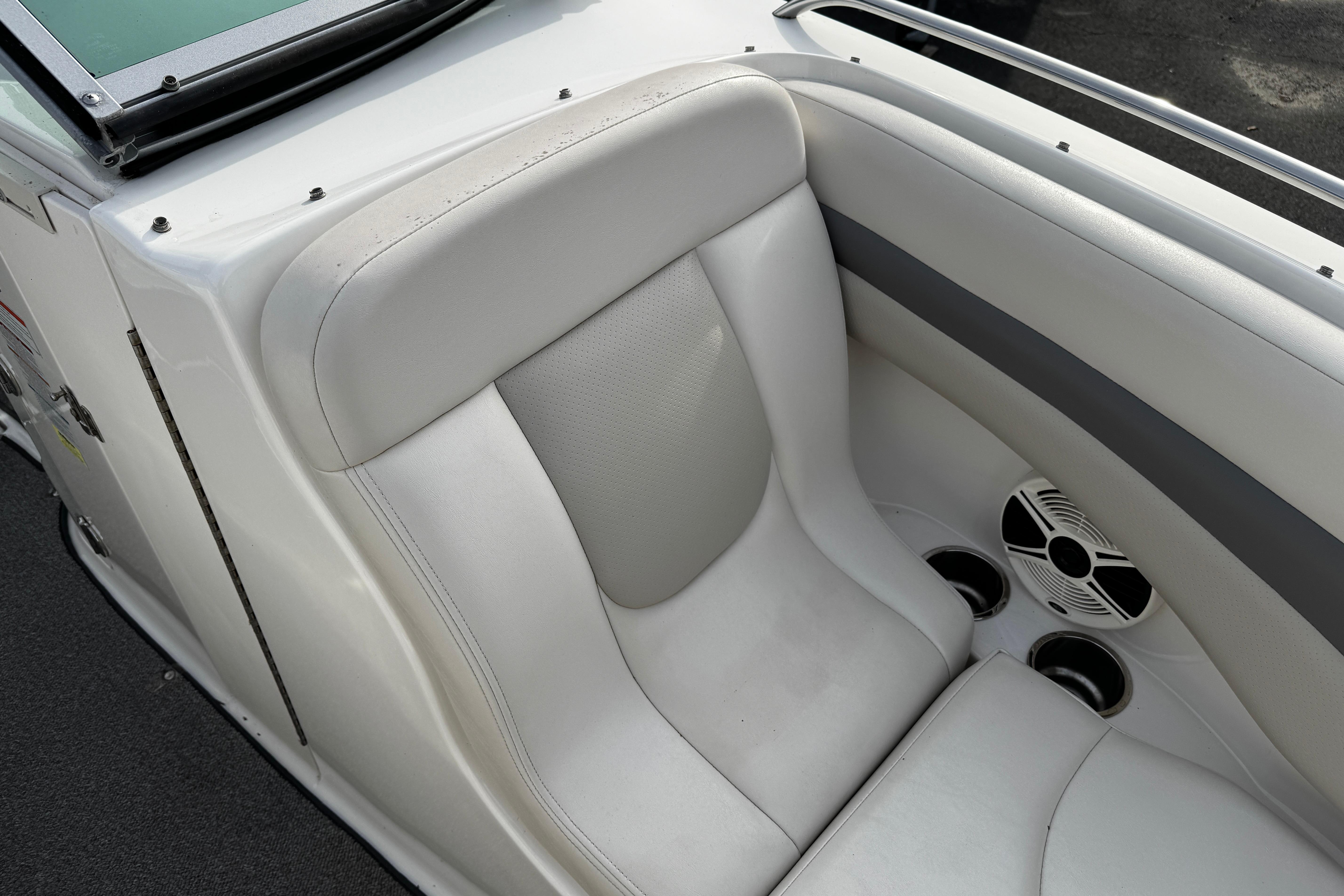 2008 Chaparral 256 SSi boat interior with white seating and built-in speakers.