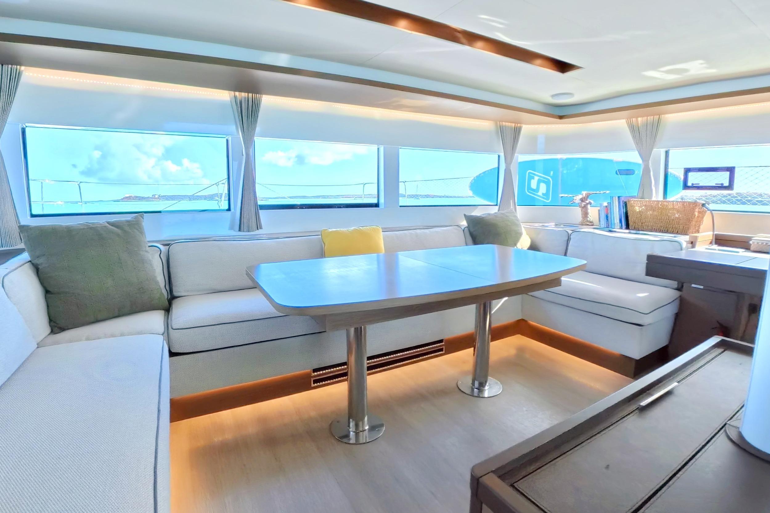 Luxurious interior of 2023 Lagoon 50 yacht with spacious seating and ocean views.