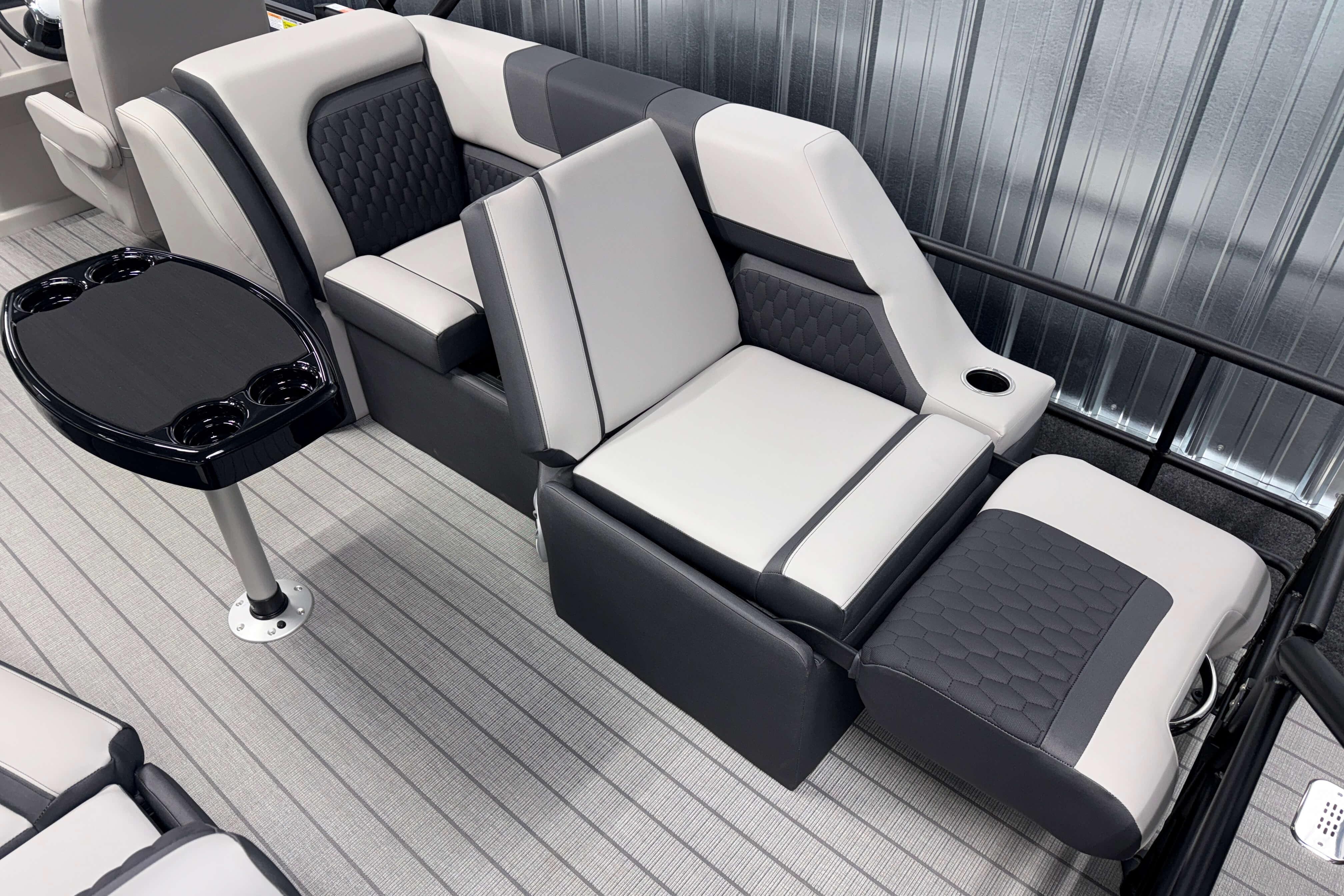 Luxurious seating in 2026 Sylvan L3 SLZ boat with sleek design and cup holders.