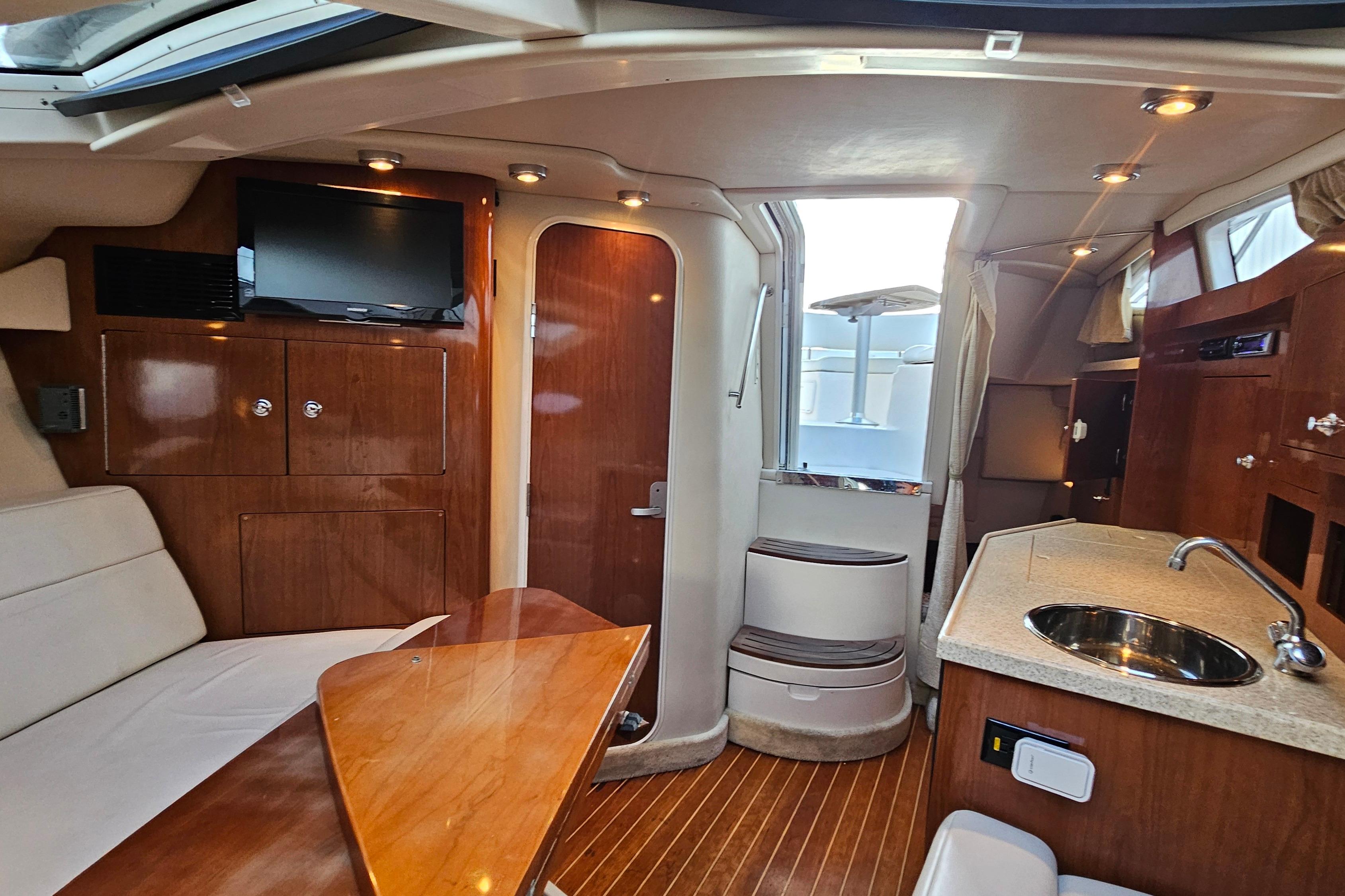 Interior of 2005 Regal 3060 Window Express yacht with wood finishes and modern amenities.