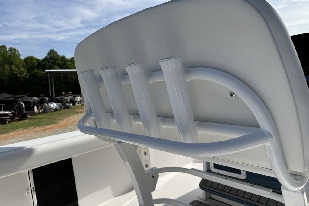 2026 Tidewater 232 LXF boat seat with integrated rod holders, outdoor setting.