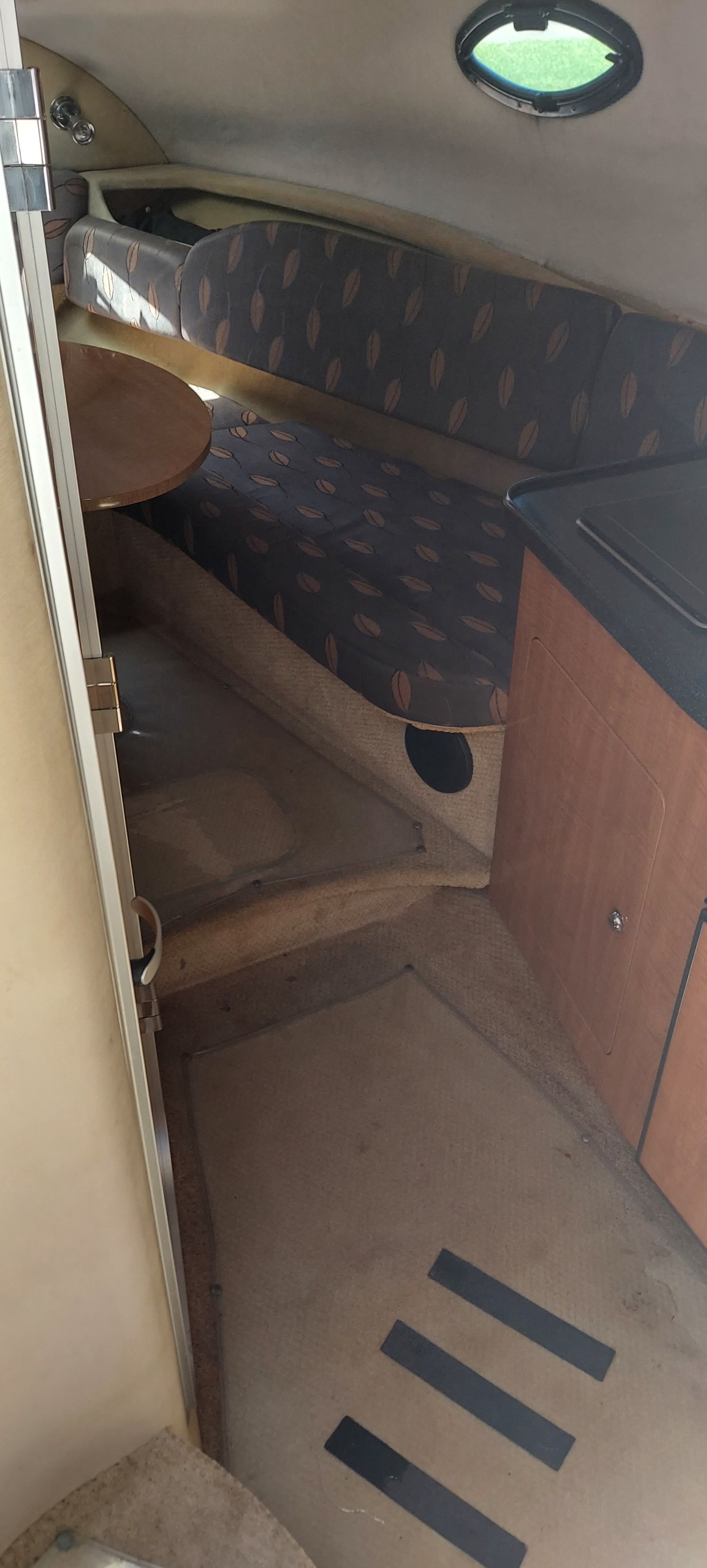 Interior of a 2004 Regal Commodore 2465 boat with seating area.