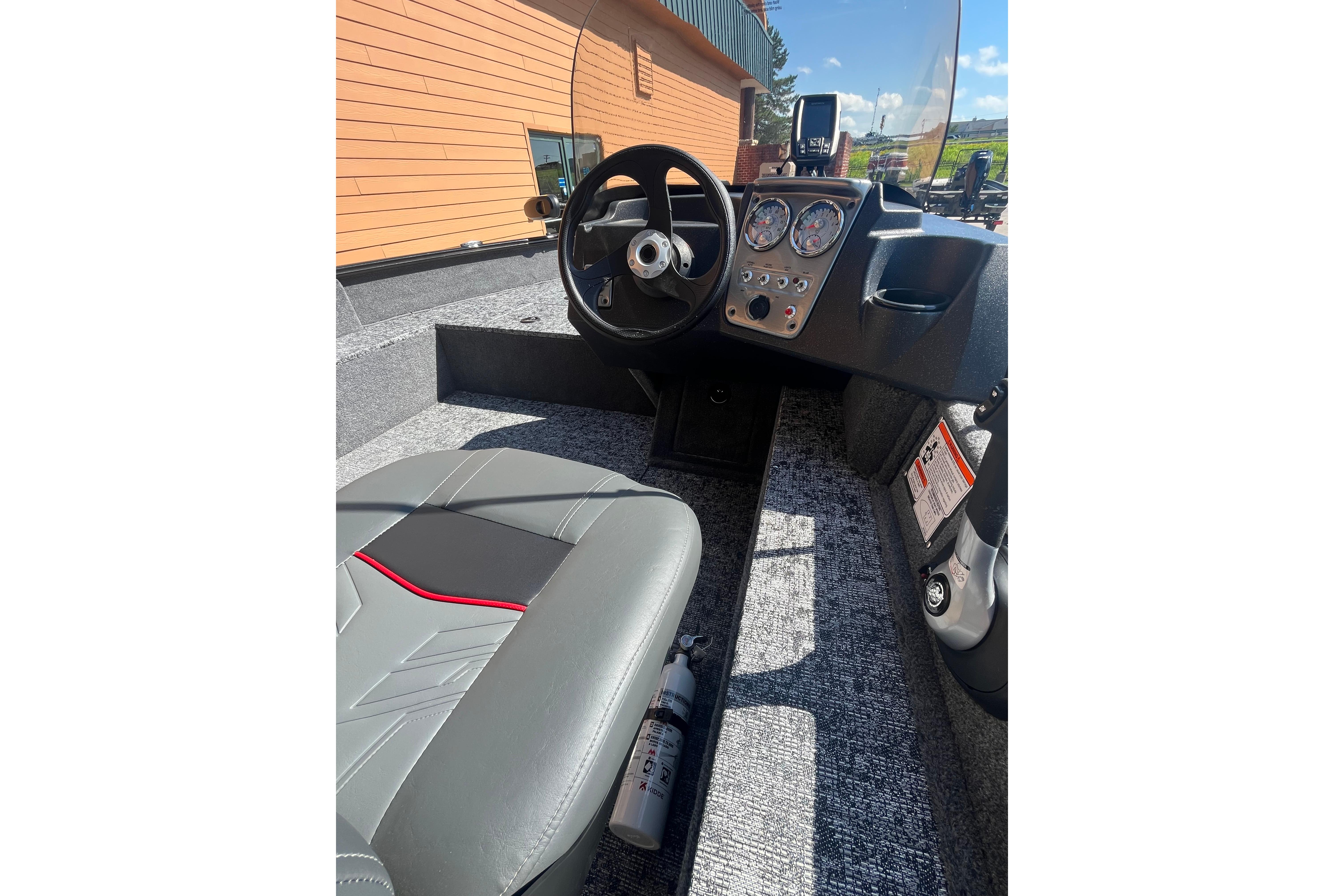 2026 Tracker Pro Guide V-16 SC boat interior with steering wheel and dashboard controls.