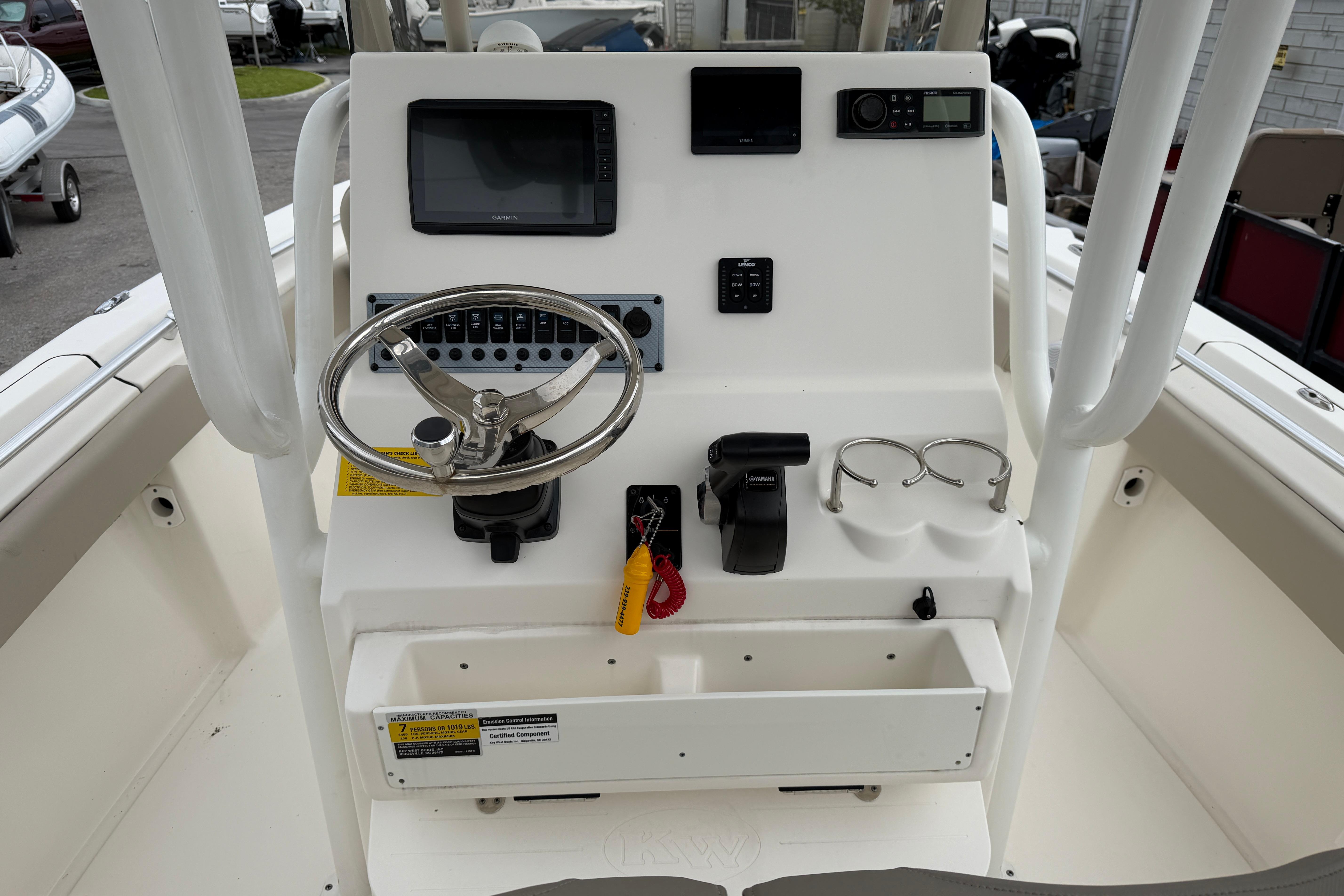 2022 Key West 219 FS boat console with steering wheel and electronic controls.