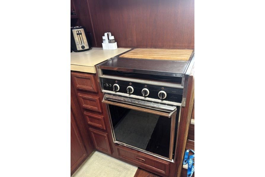 1980 Viking 43 Convertible kitchen with vintage stove and wooden cabinetry.