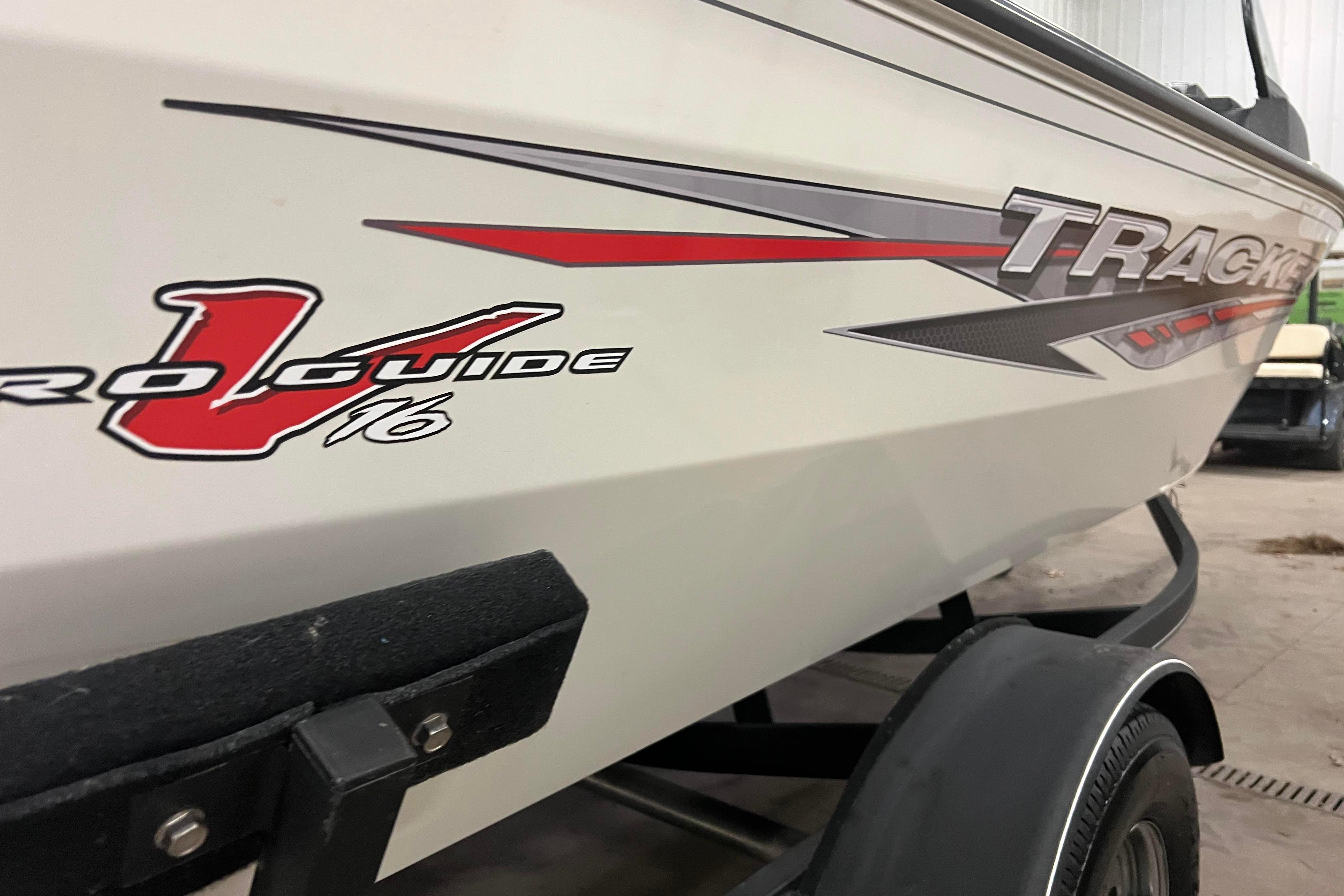 2022 Tracker Pro Guide V-16 WT boat on trailer, side view with logo.