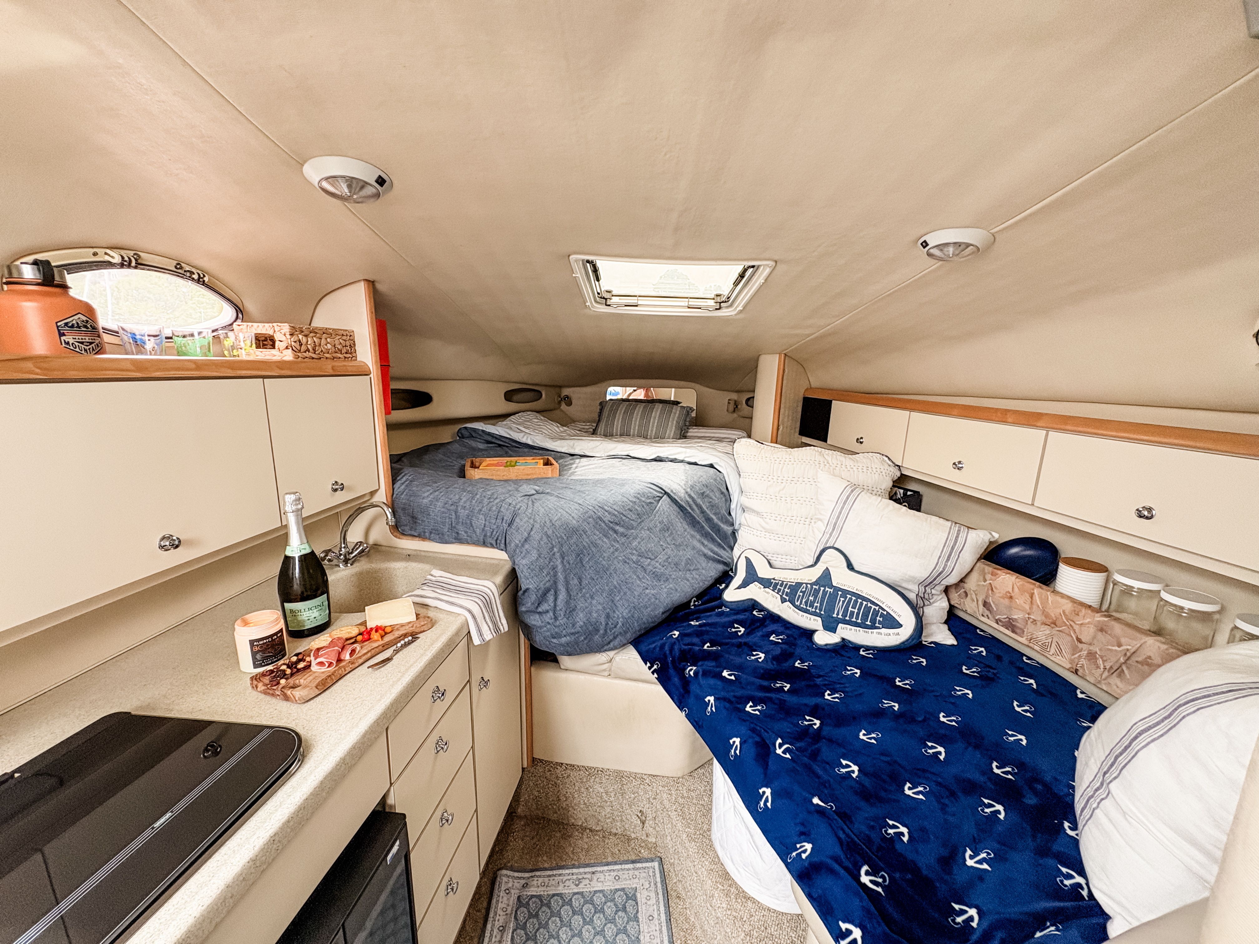 Interior of a 1997 Wellcraft Martinique yacht with cozy bed and kitchenette.