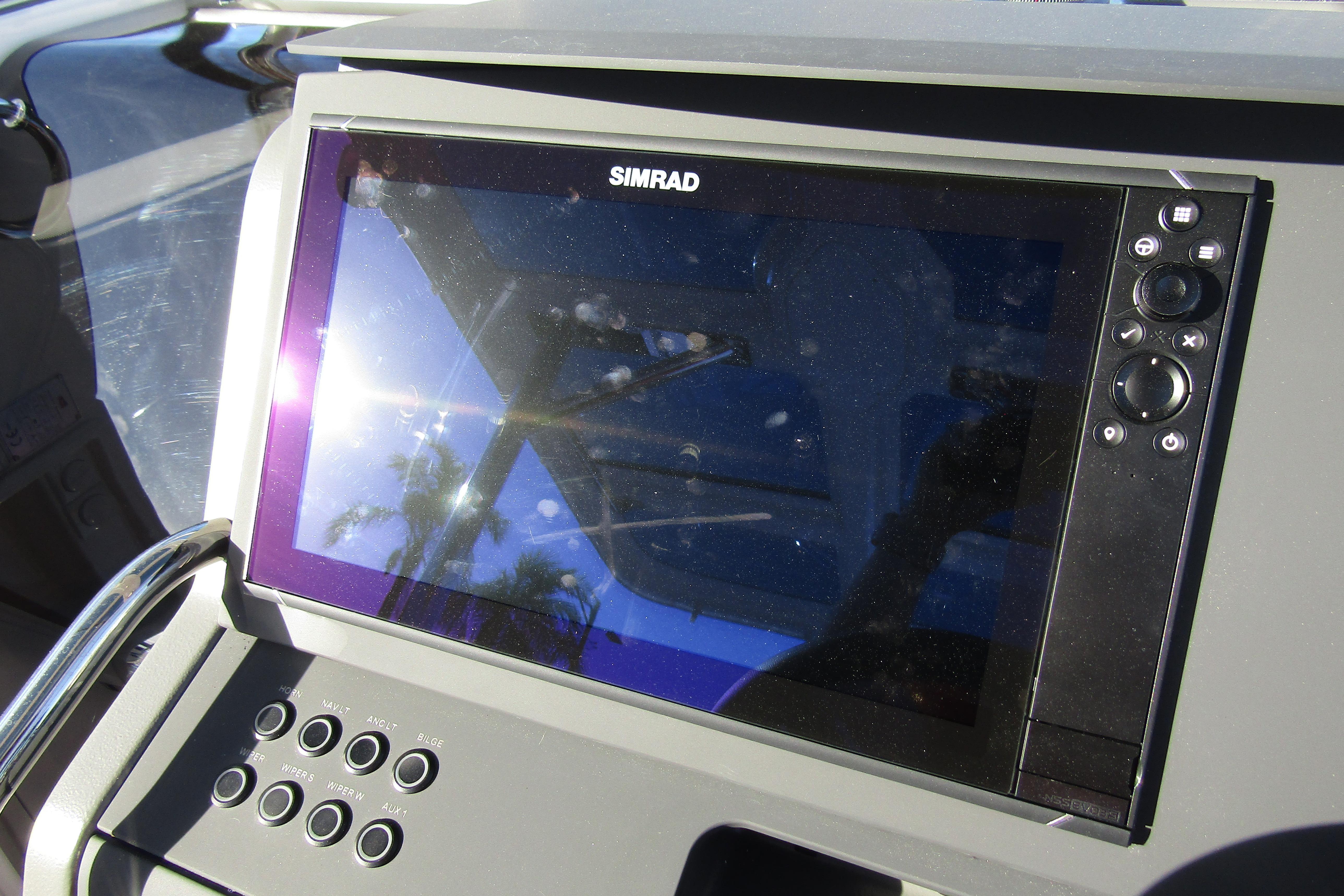Simrad display on 2025 Nimbus Tender 9 boat dashboard, reflecting sunlight.