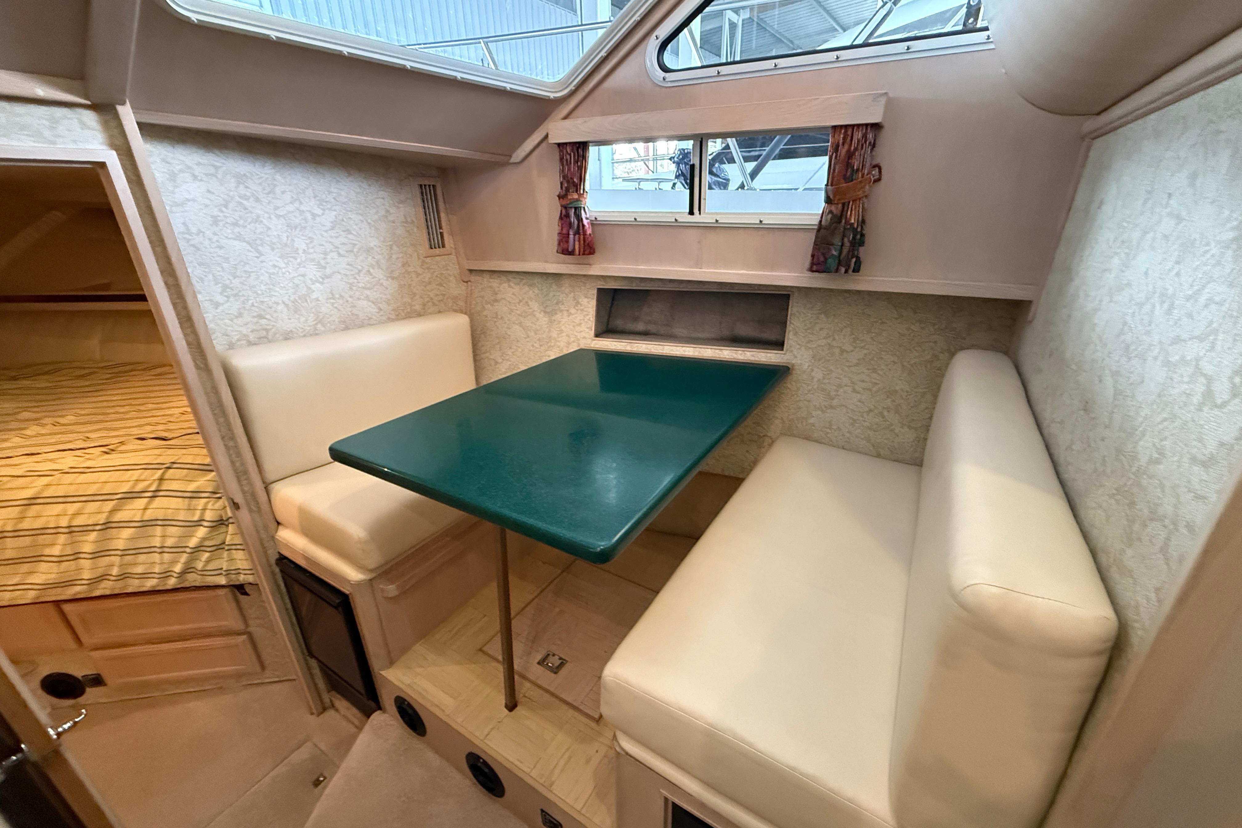 1994 Tollycraft 45 Cockpit Motor Yacht interior with dining area and cozy seating.