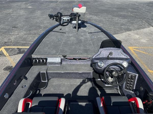 2025 Phoenix 920 Elite boat interior with steering wheel and seating, parked on asphalt.