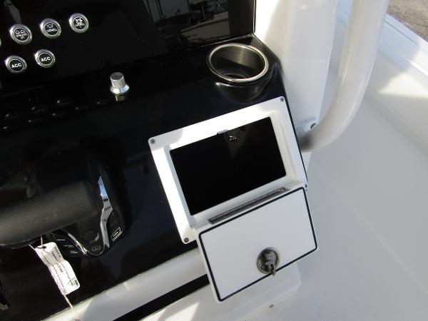 Wellcraft 243 Fisherman 2025 console with cup holder and storage compartment.