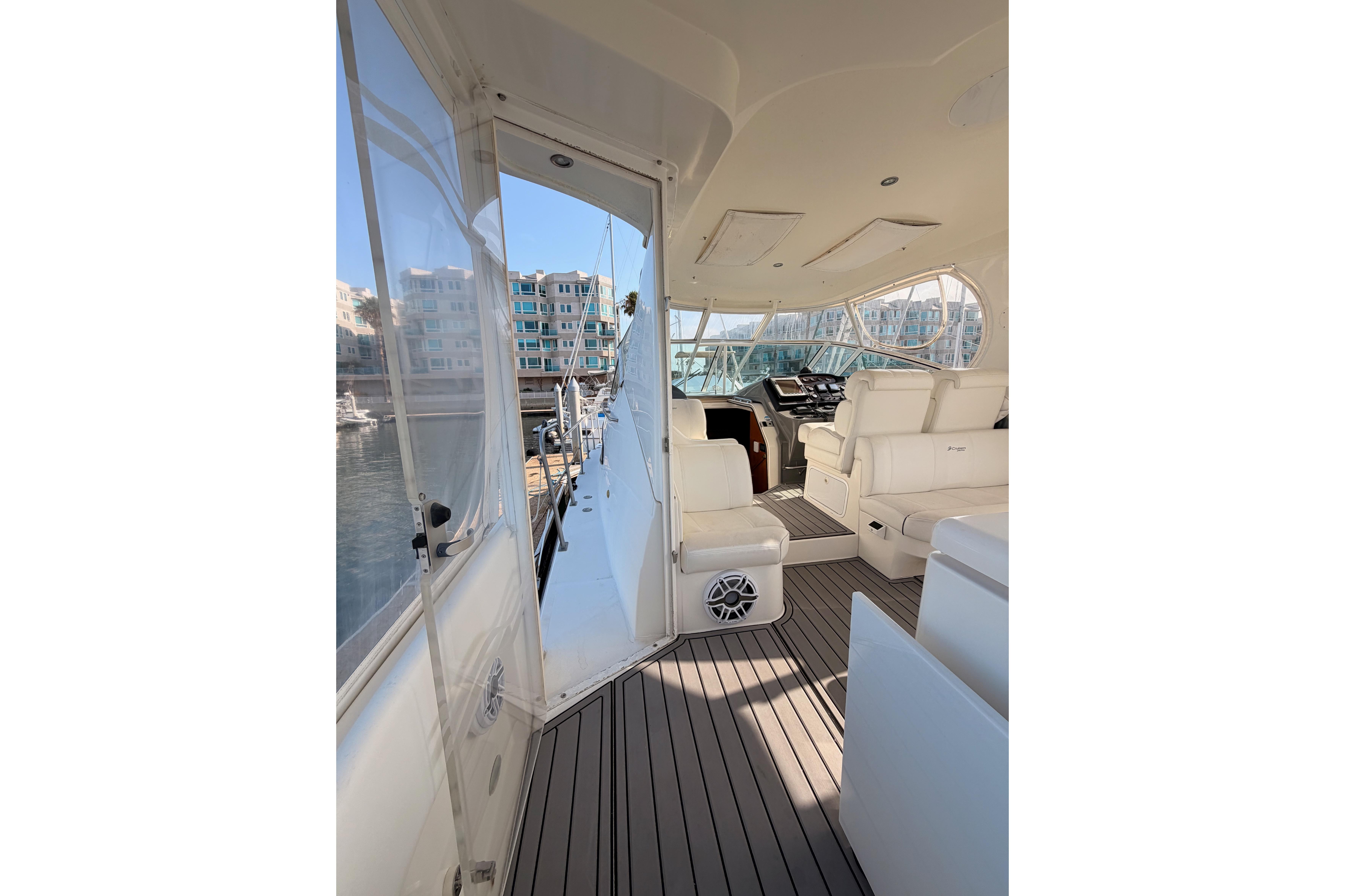 2005 Cruisers Yachts 405 Express Motoryacht interior with white seating and marina view.