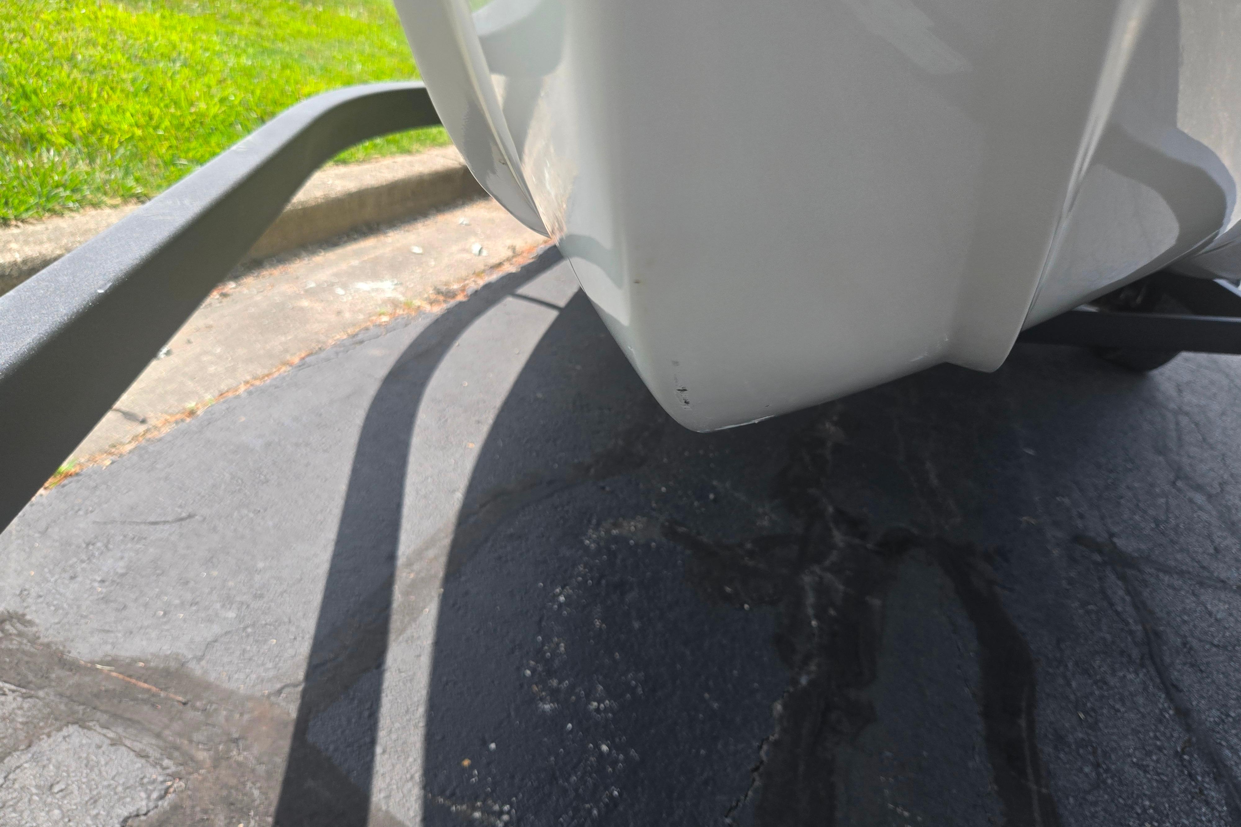 Close-up of a 2023 Tahoe 200 S boat trailer on pavement.