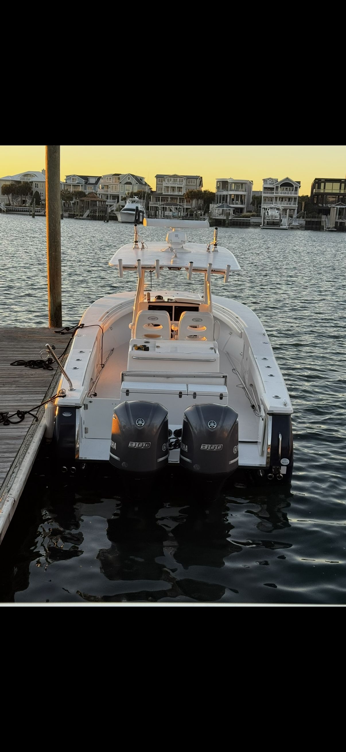 A 2014 Southport 29 Center Console boat docked. It features twin outboard engines.