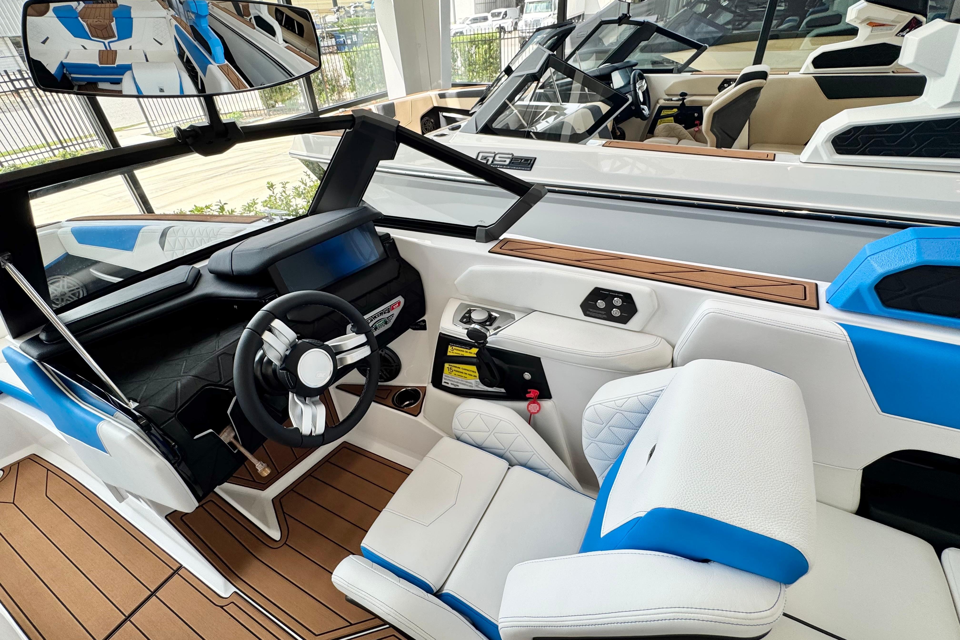 2026 Nautique Super Air Nautique GS22 interior with modern dashboard and blue-white seating.