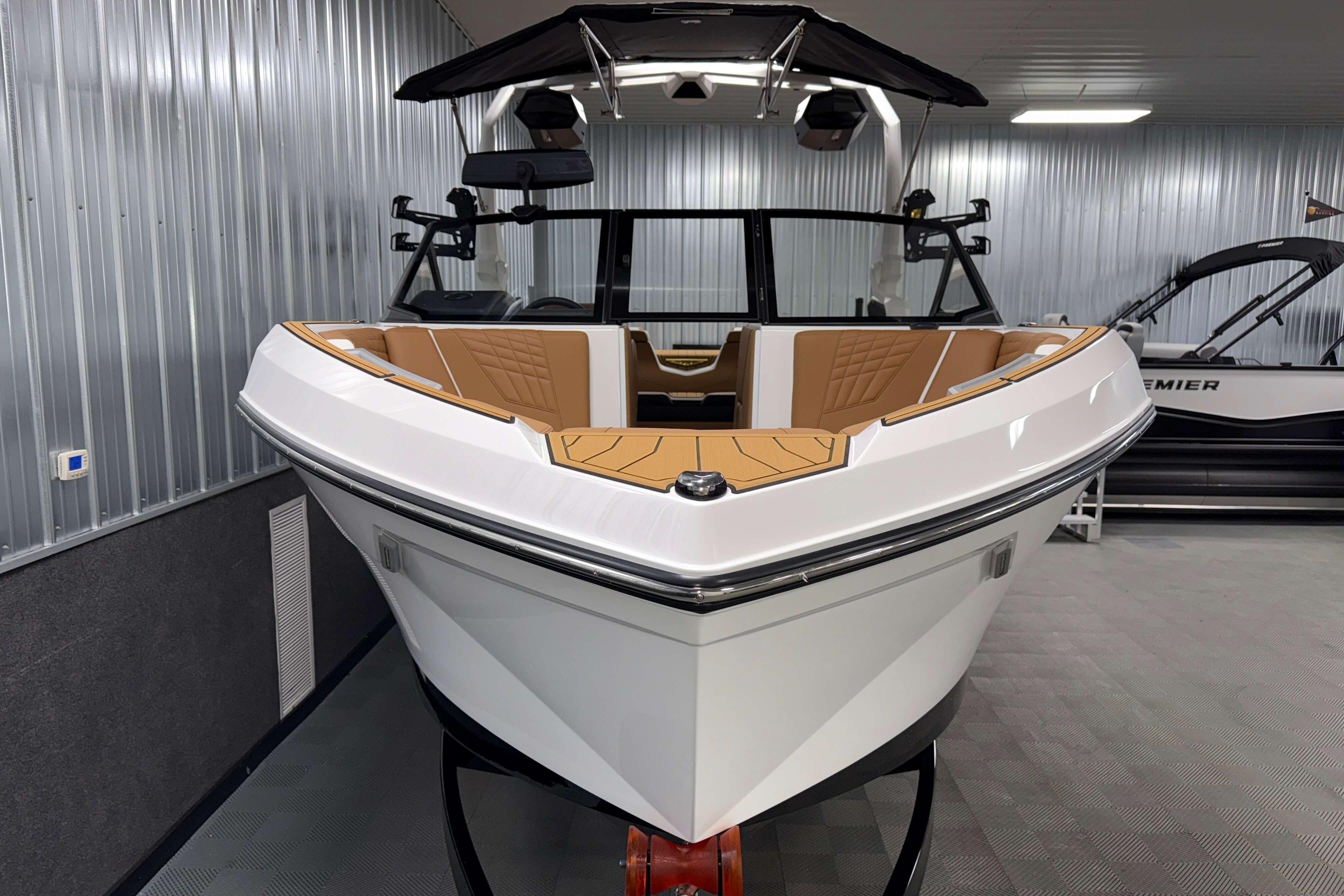 2026 Nautique Super Air Nautique S23 boat in showroom, sleek design, luxury interior.