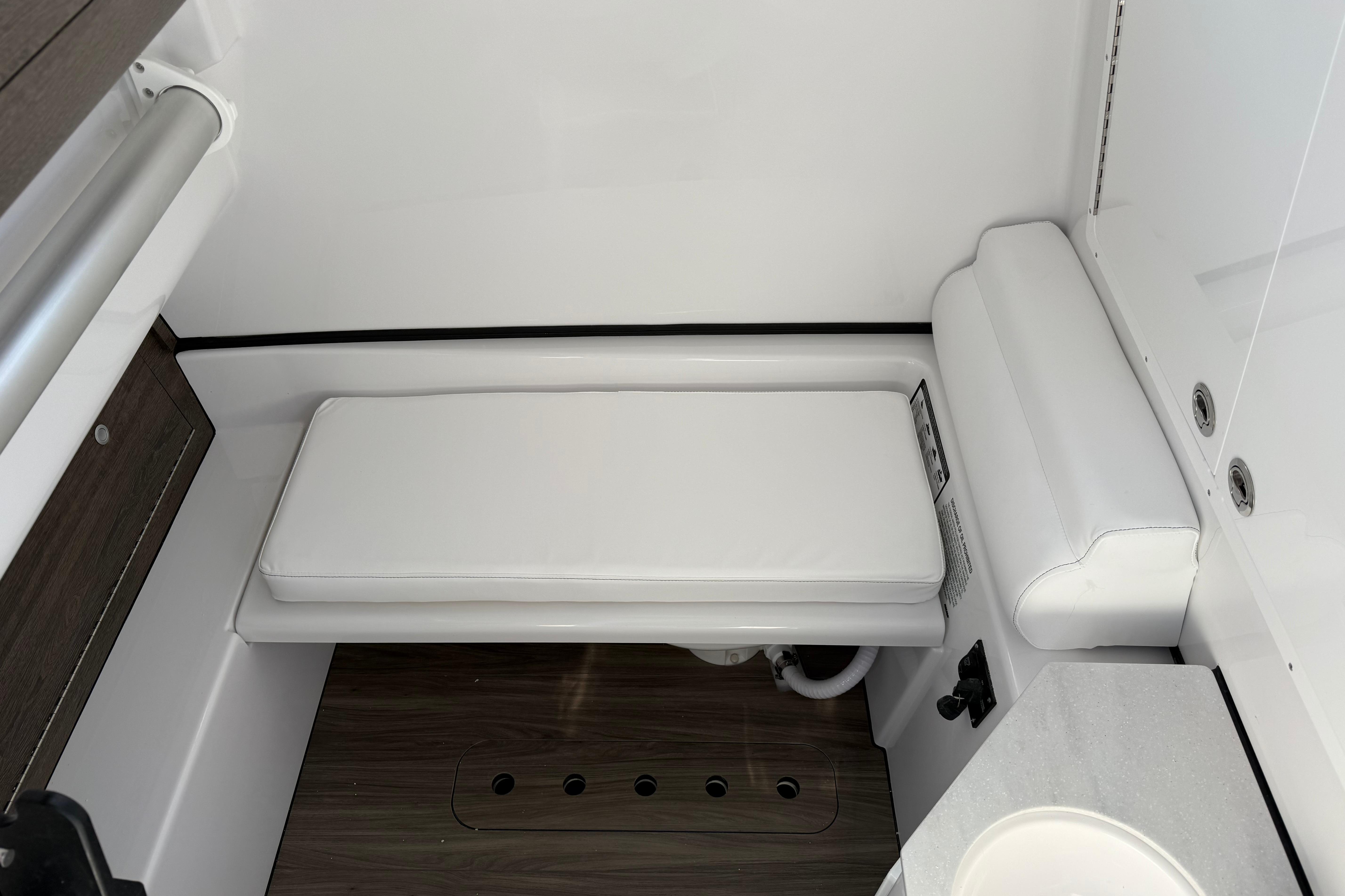 Interior of 2026 Sportsman Open 322 Center Console boat, featuring white cushioned seating.